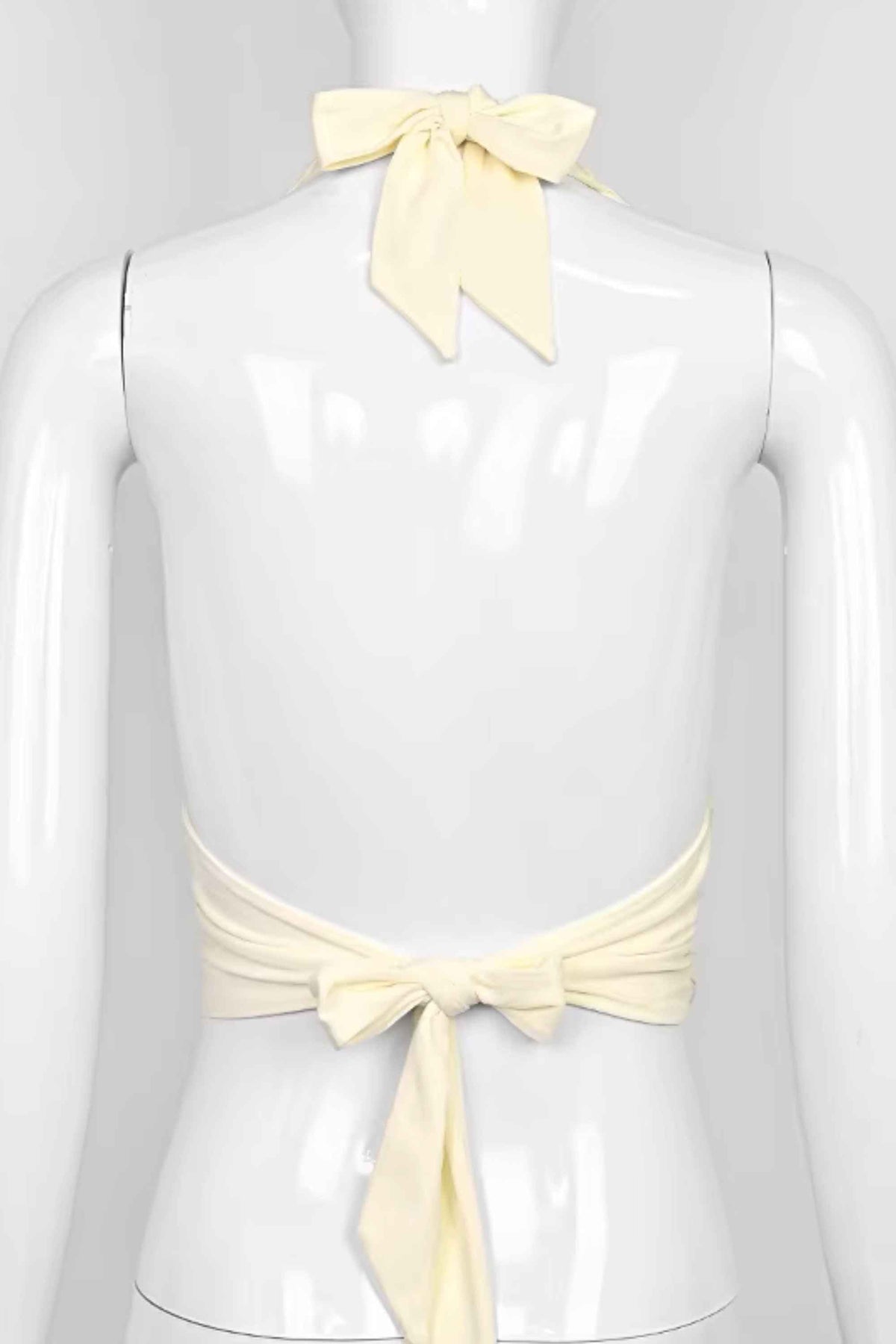 Woman wearing a figure flattering Aby Halter Top - Butter Yellow BODYCON COLLECTION Pty Ltd
