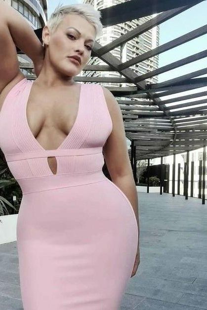 Woman wearing a figure flattering Bay Bandage Dress - Blush Pink Bodycon Collection