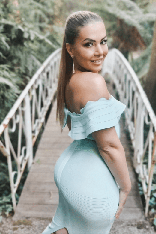 Woman wearing a figure flattering Billie Bandage Midi Dress - Lipstick Red Bodycon Collection