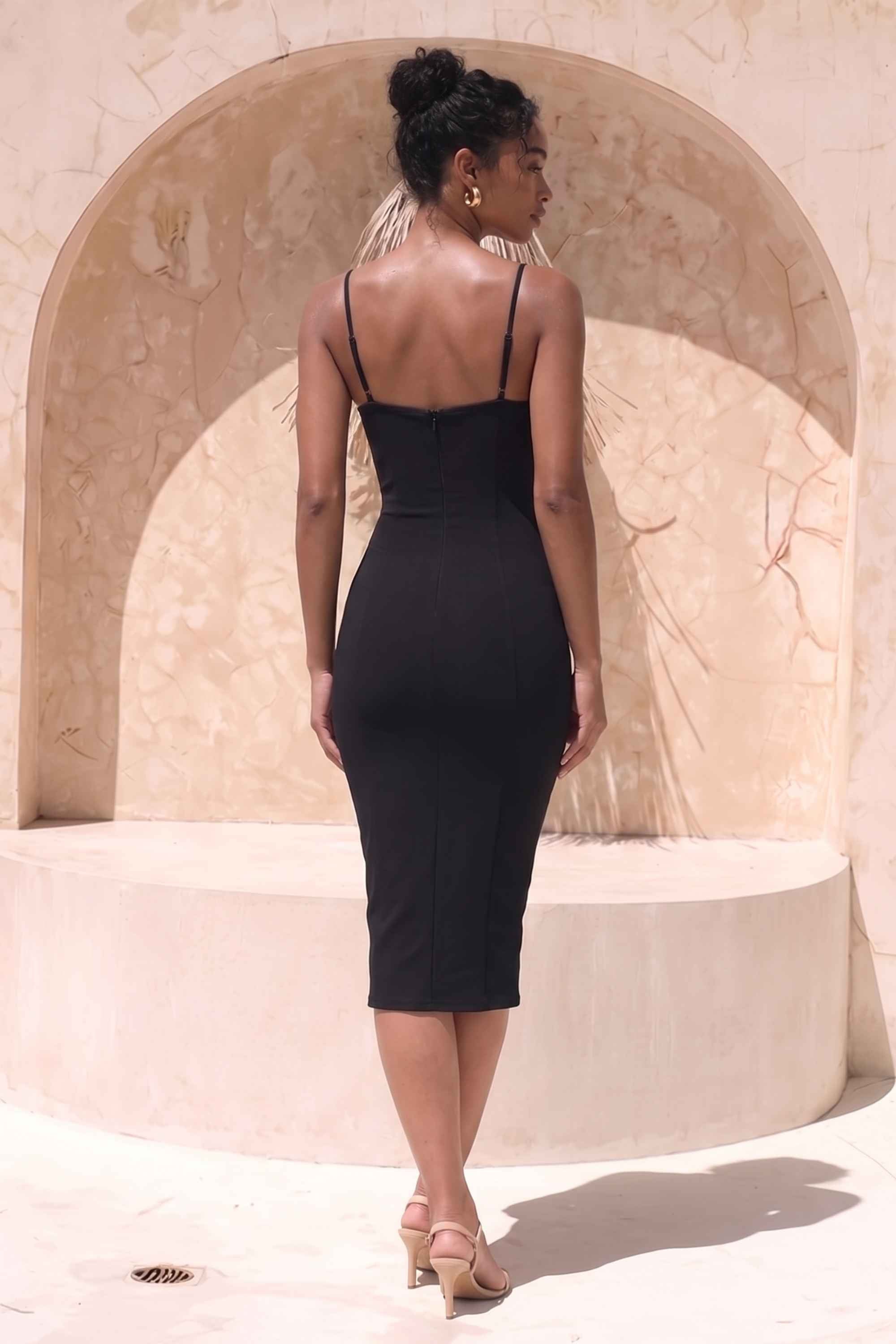 Woman wearing a figure flattering Blanche Bandage Midi Dress - Classic Black BODYCON COLLECTION