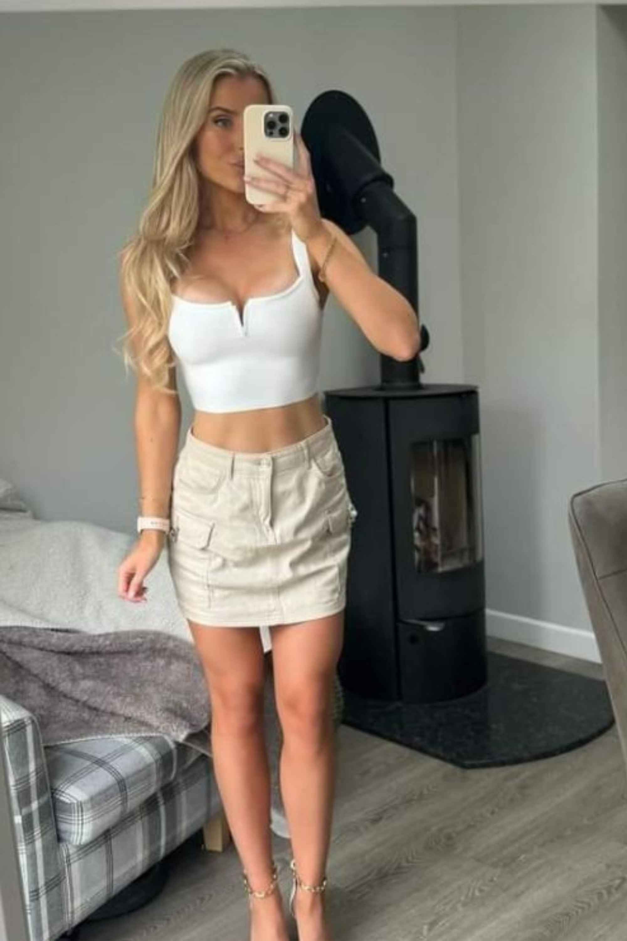 Woman wearing a figure flattering Brooke Bandage Crop Top - Pearl White BODYCON COLLECTION