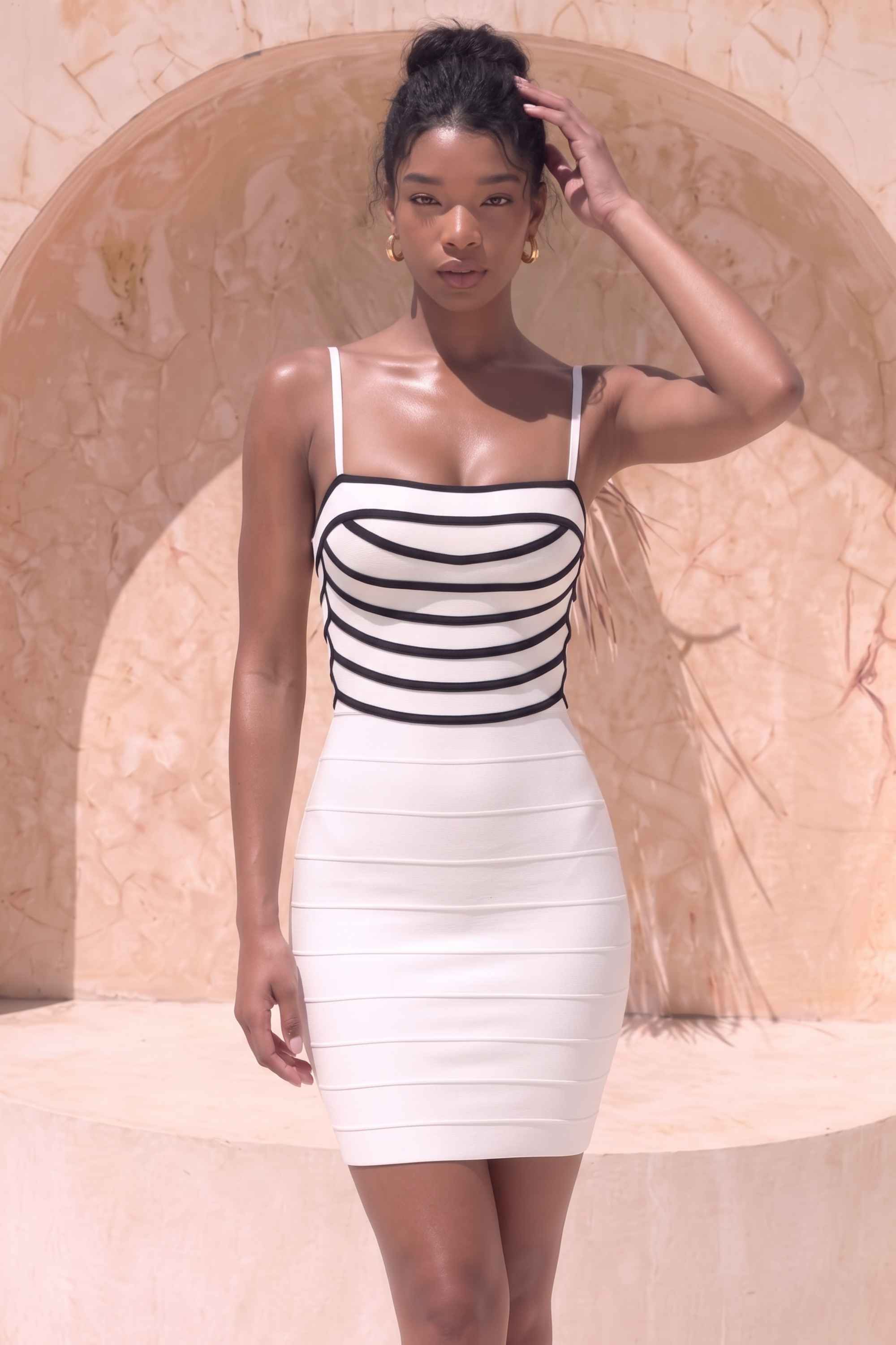 Woman wearing a figure flattering Carter Bandage Mini Dress - White Pearl BODYCON COLLECTION