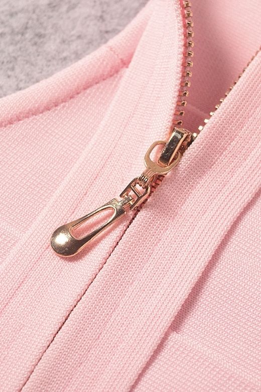 Woman wearing a figure flattering Elli Bandage Crop Top - Dusty Pink BODYCON COLLECTION