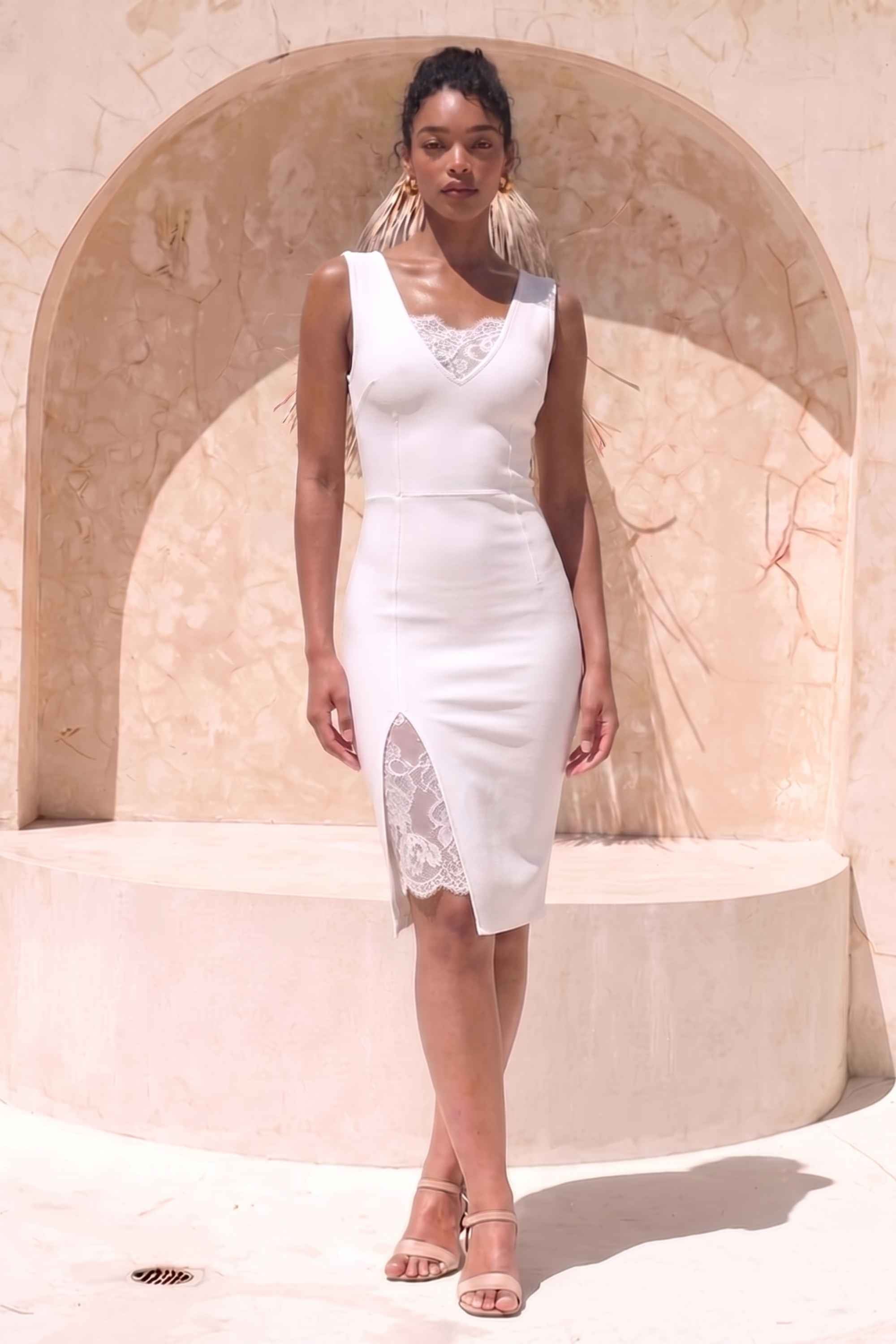 Woman wearing a figure flattering Elsa Bodycon Dress - White Pearl BODYCON COLLECTION Pty Ltd