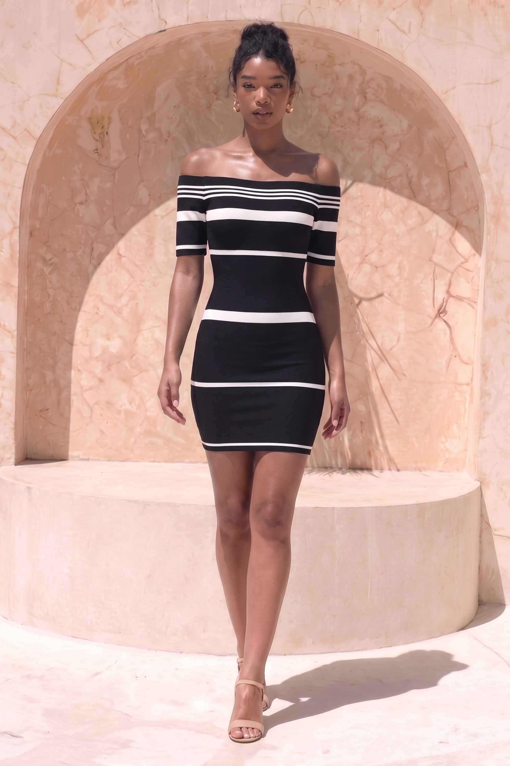 Woman wearing a figure flattering Evelyn Bandage Mini Dress - Classic Black BODYCON COLLECTION Pty Ltd