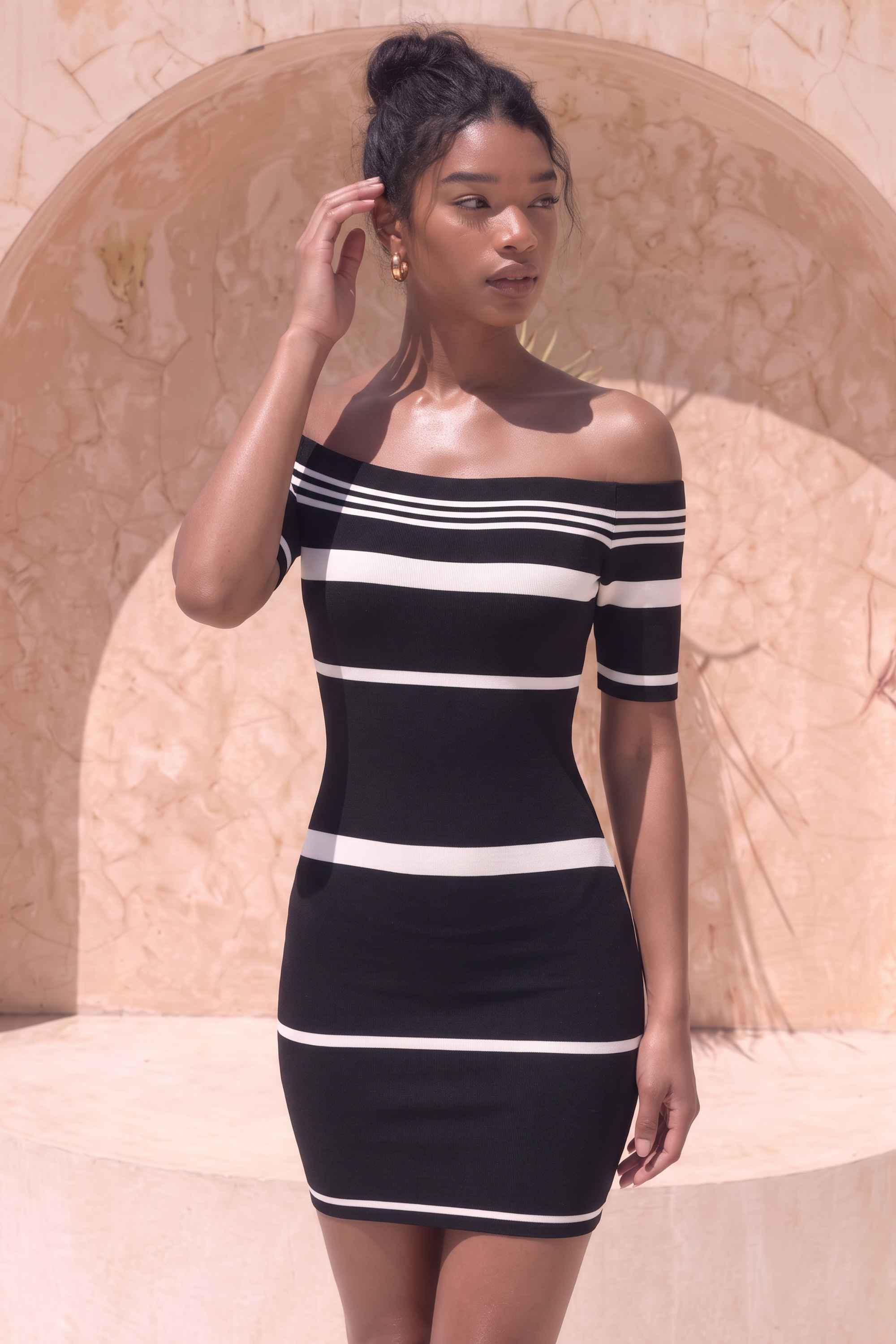 Woman wearing a figure flattering Evelyn Bandage Mini Dress - Classic Black BODYCON COLLECTION Pty Ltd