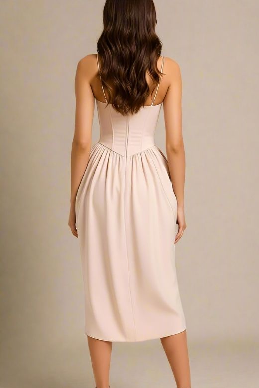 Woman wearing a figure flattering Everly Midi Dress - Peach BODYCON COLLECTION