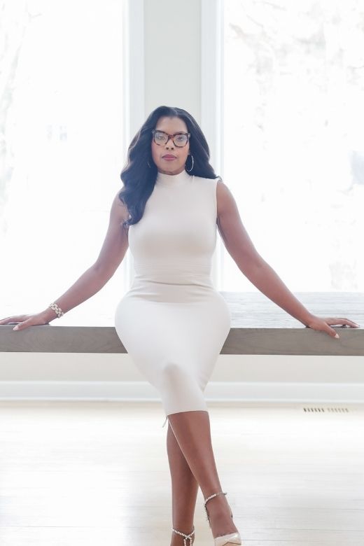 Woman wearing a figure flattering Grace Bandage Midi Dress - Cream Bodycon Collection