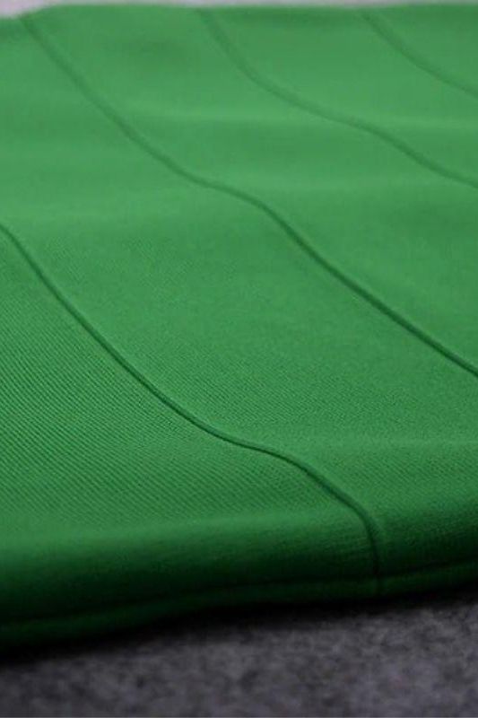 Woman wearing a figure flattering  Heidi Bandage Midi Dress - Emerald Green Bodycon Collection
