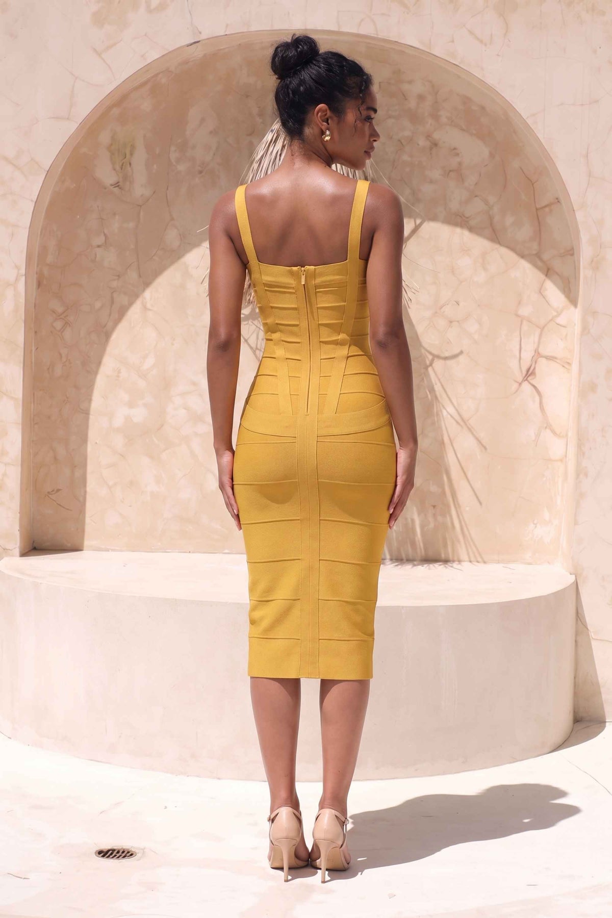 Woman wearing a figure flattering mustard yellow party dress Heidi Bandage Midi Dress - Mustard Yellow Bodycon Collection