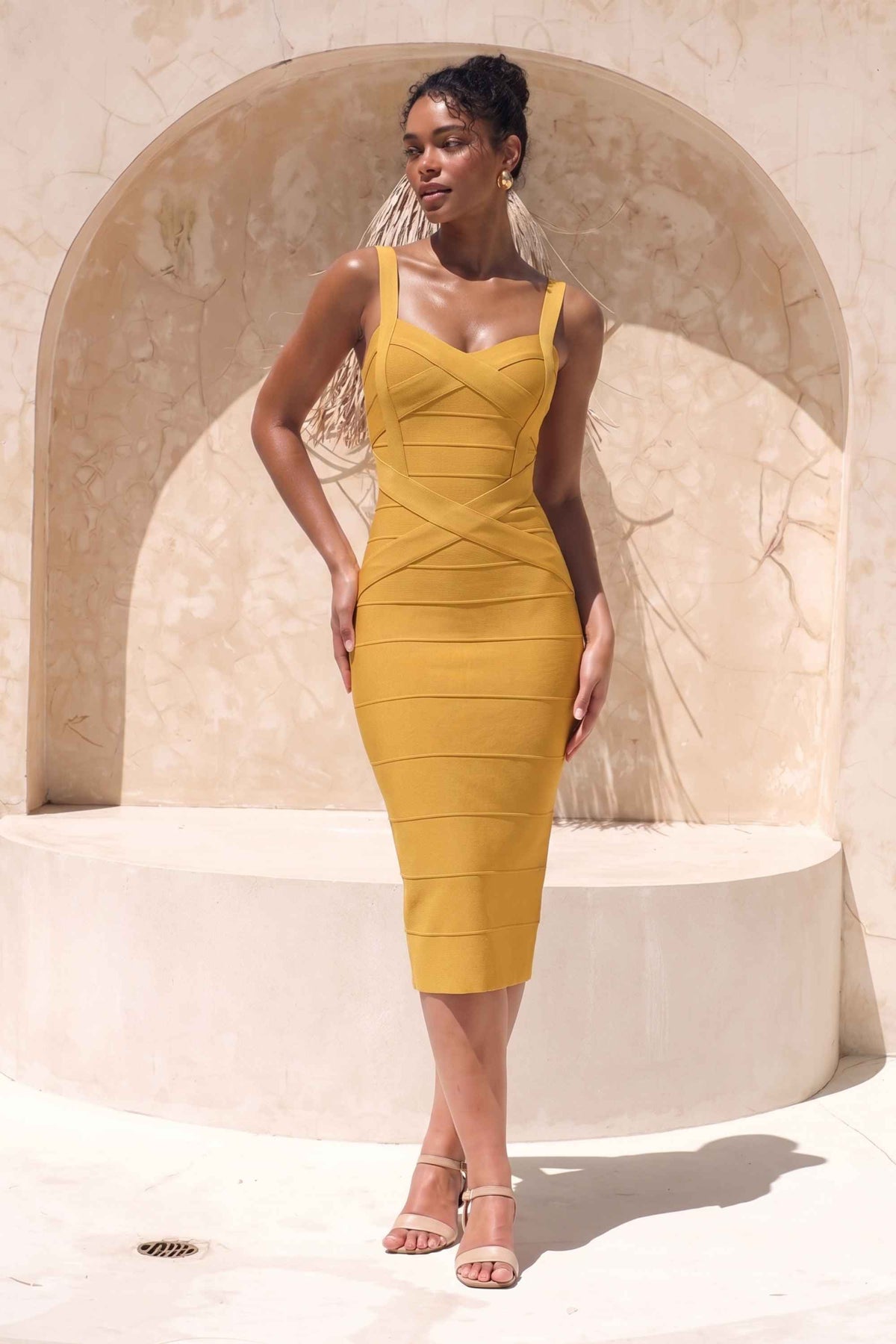 Woman wearing a mustard yellow party dress Heidi Bandage Midi Dress - Mustard Yellow Bodycon Collection
