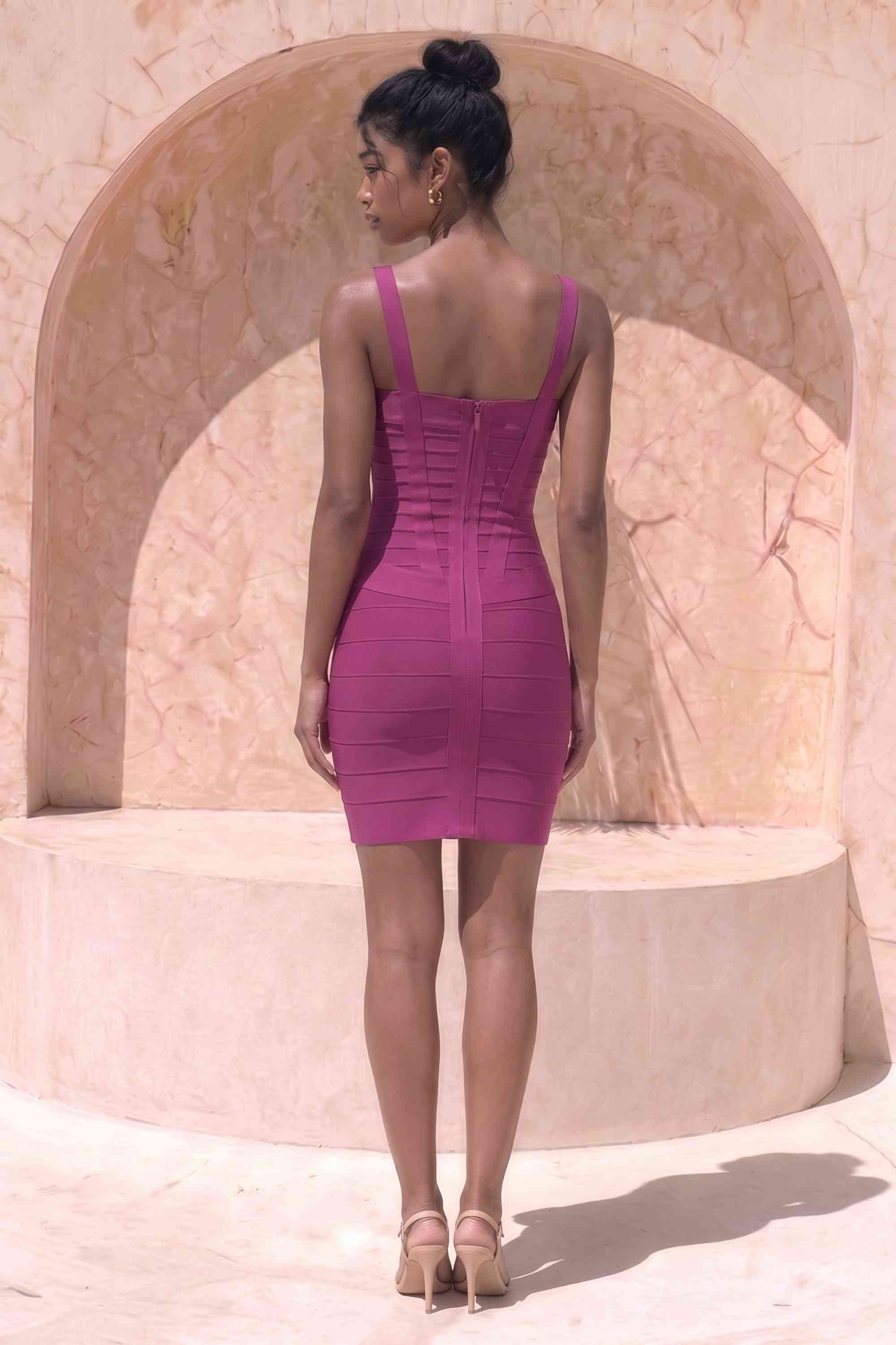 Woman wearing a figure flattering Heidi Bandage Mini Dress - Magenta Pink Bodycon Collection