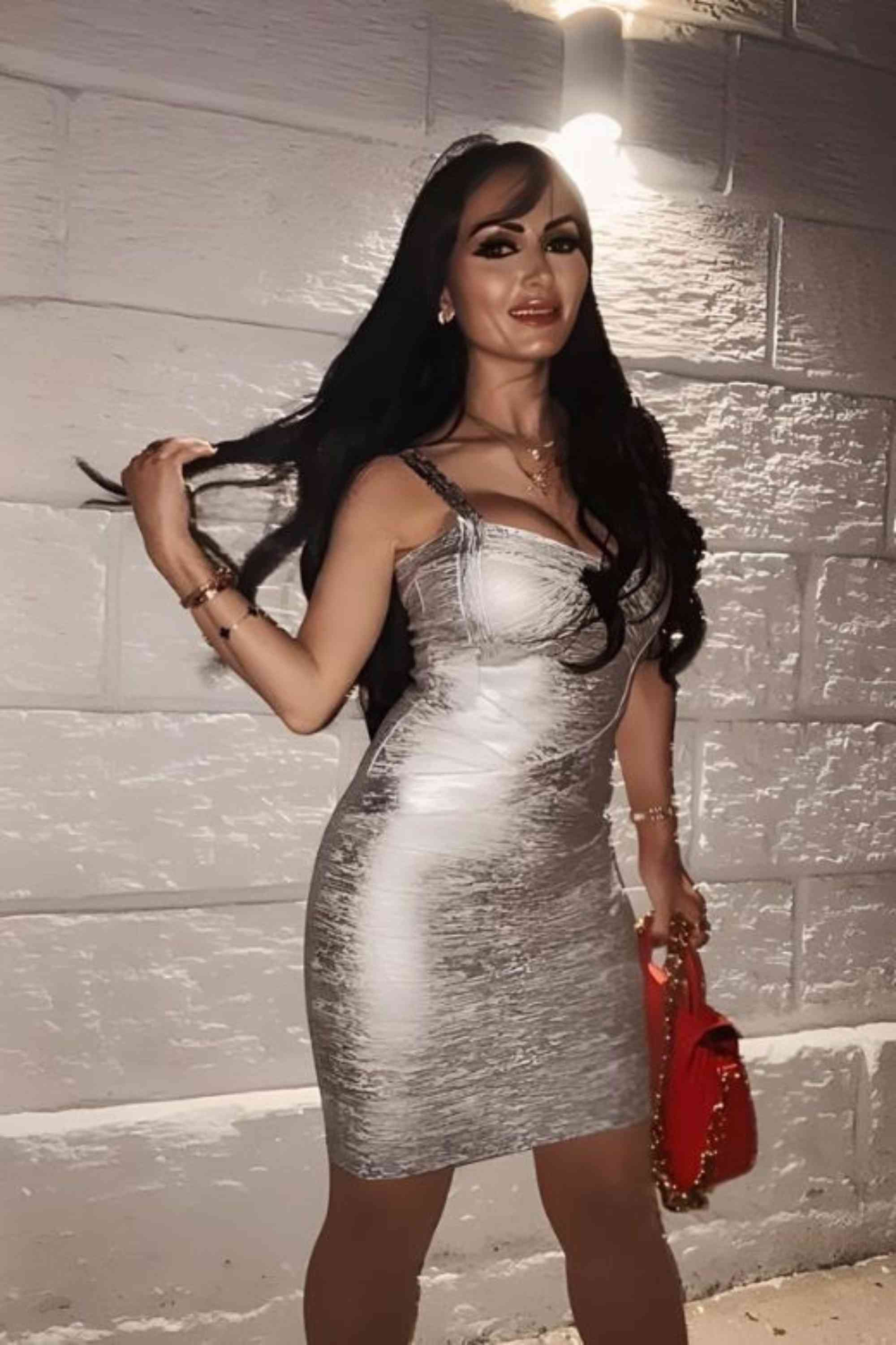 Woman wearing a figure flattering Heidi Bandage Mini Dress - Silver Bodycon Collection
