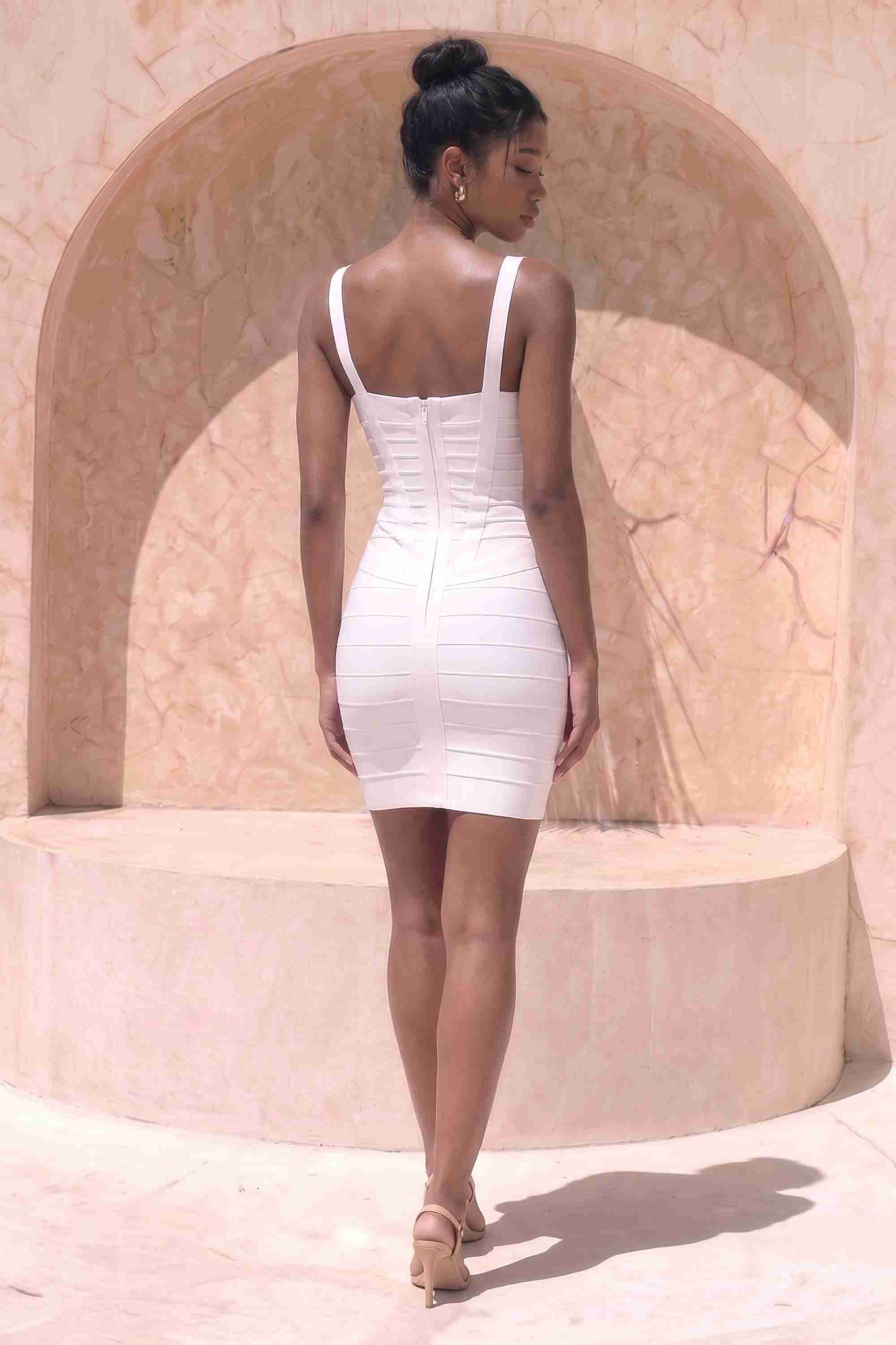 Woman wearing a figure flattering Heidi Bandage Mini Dress - White Pearl Bodycon Collection