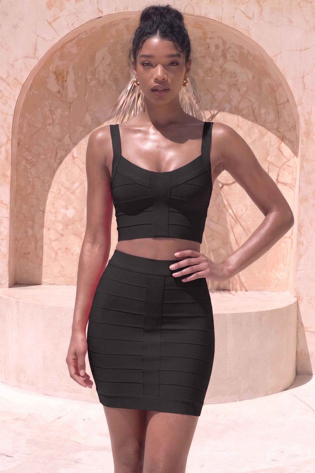 Woman wearing a figure flattering India Bandage Top and Mini Skirt Outfit Set - Classic Black BODYCON COLLECTION
