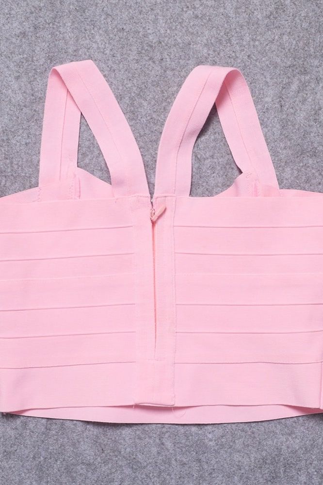 Woman wearing a figure flattering Jay Bandage Crop Top - Dusty Pink BODYCON COLLECTION