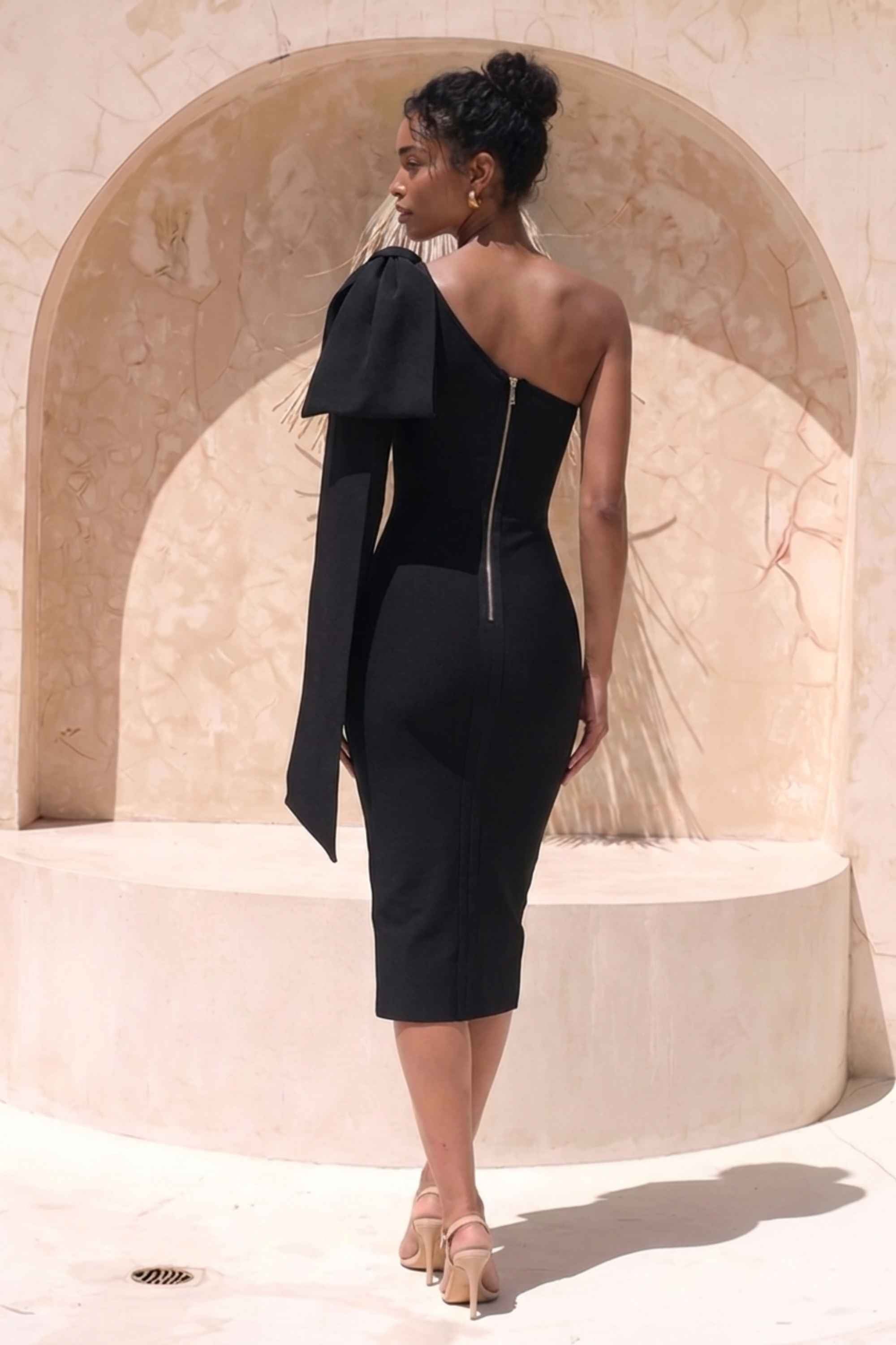 Woman wearing a figure flattering Lela Long Sleeve Bandage Midi Dress - Classic Black BODYCON COLLECTION