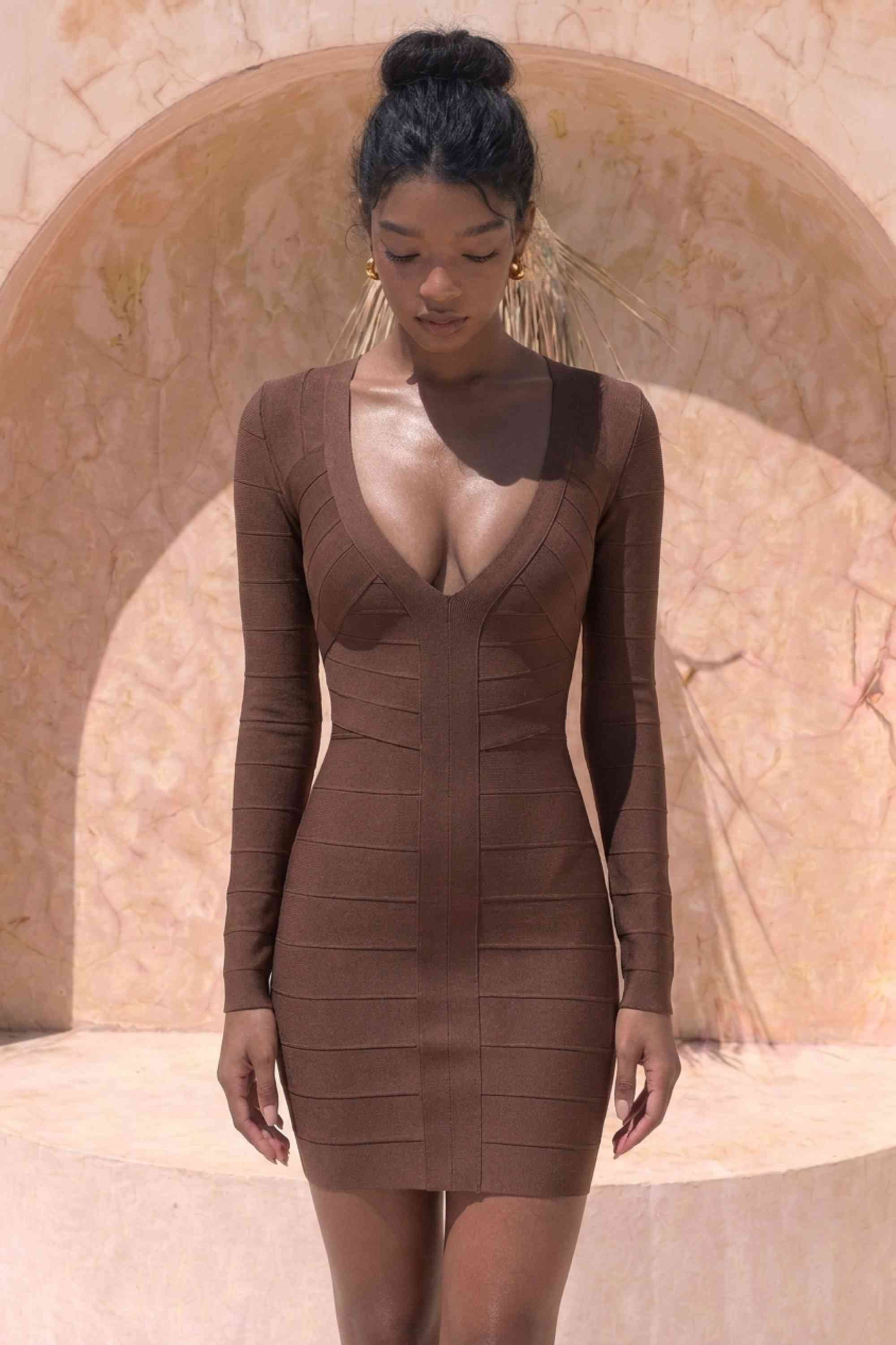 Woman wearing a figure flattering Lisa Long Sleeve Bandage Mini Dress - Chocolate Brown BODYCON COLLECTION Pty Ltd