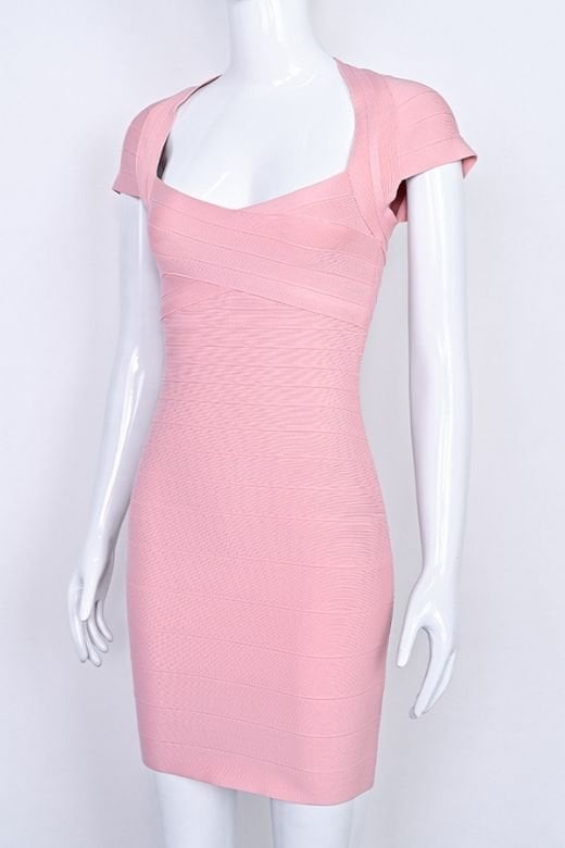 Woman wearing a figure flattering Miranda Bandage Mini Dress - Ballet Pink Bodycon Collection