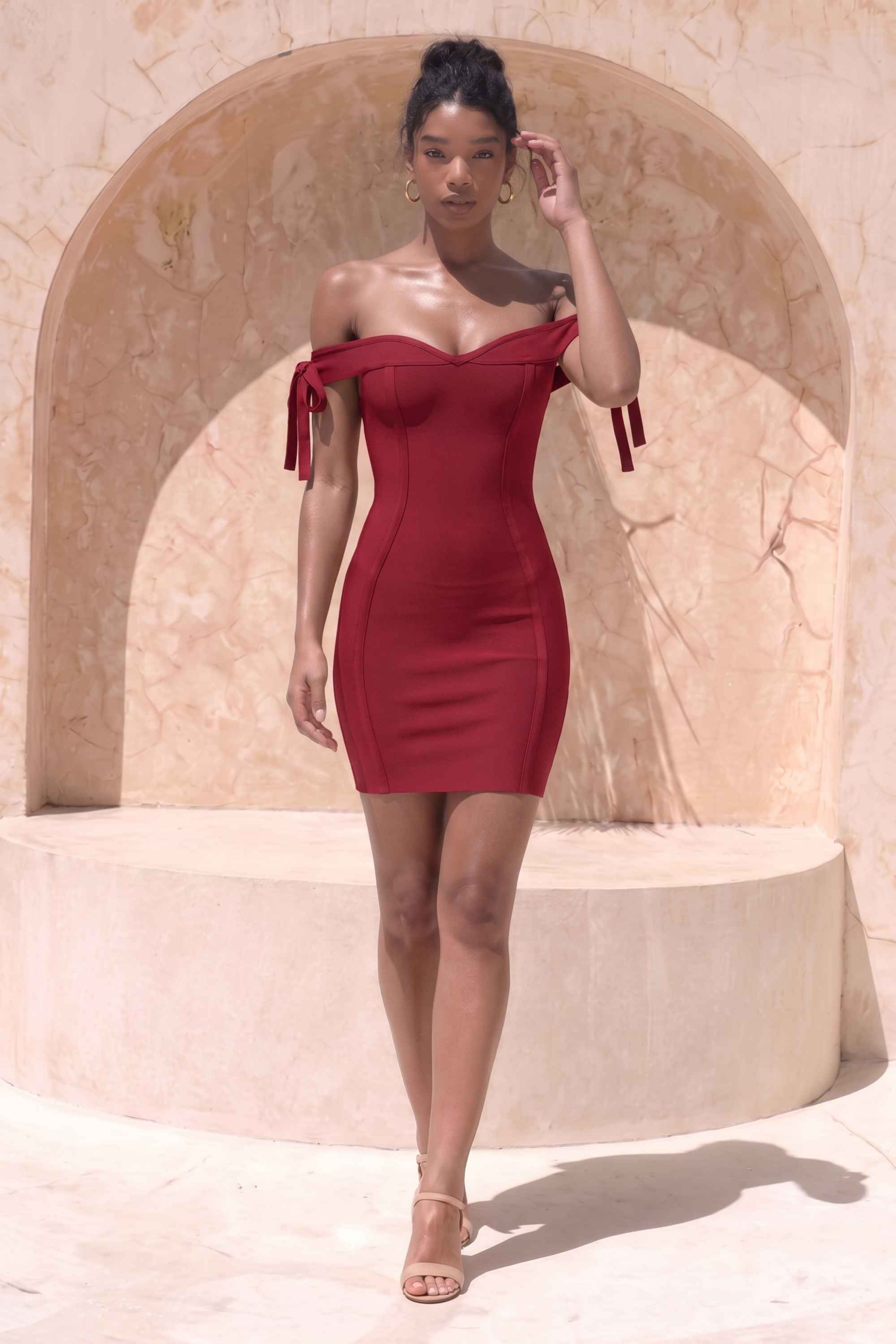 Woman wearing a figure flattering Penelope Bandage Mini Dress - Red Wine BODYCON COLLECTION