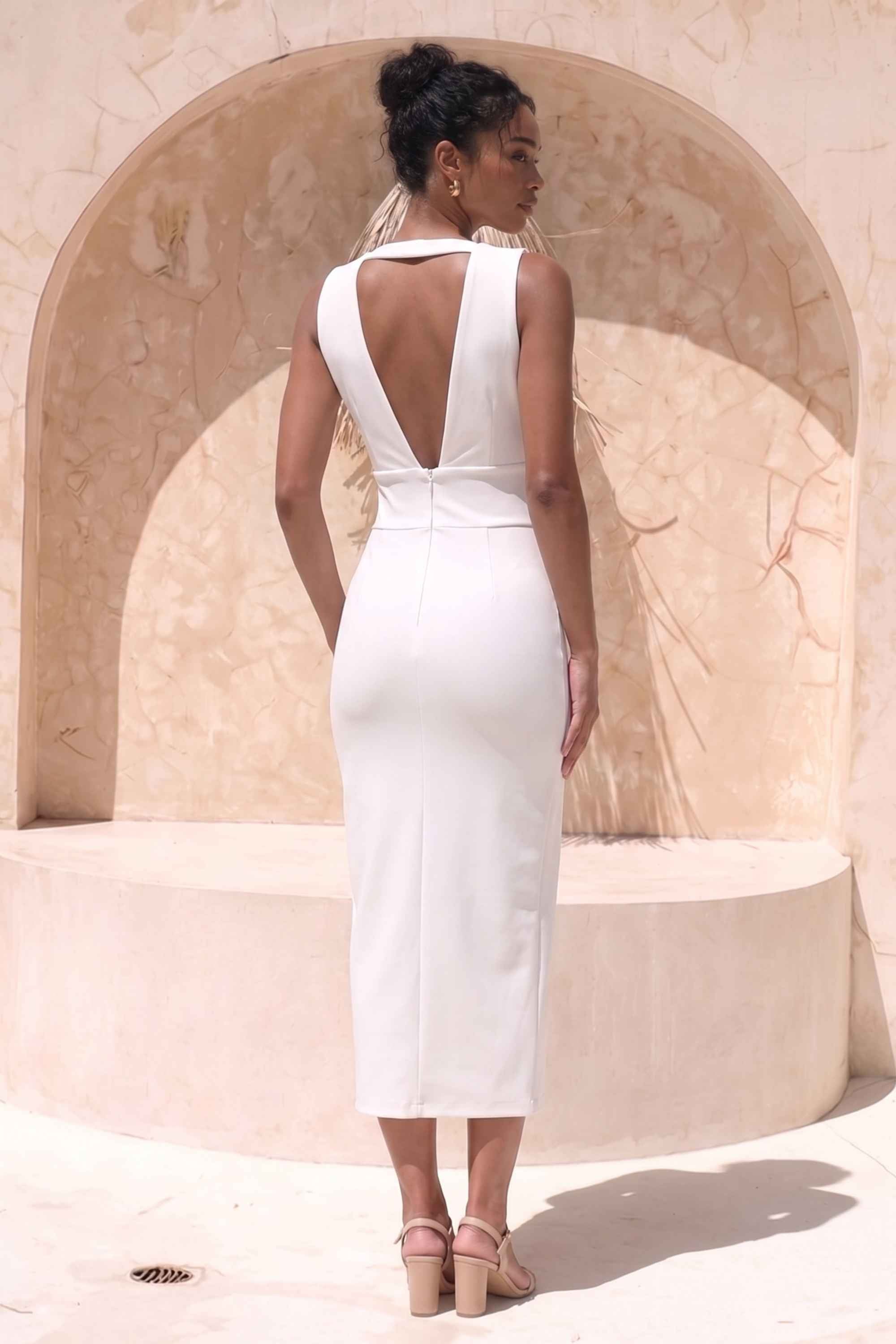 Woman wearing a figure flattering Pia Bandage Midi Dress - Pearl White BODYCON COLLECTION