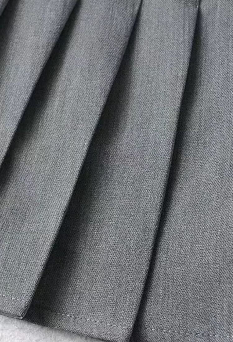 Woman wearing a figure flattering Pleated Mini Skirt - Tan Brown BODYCON COLLECTION Pty Ltd