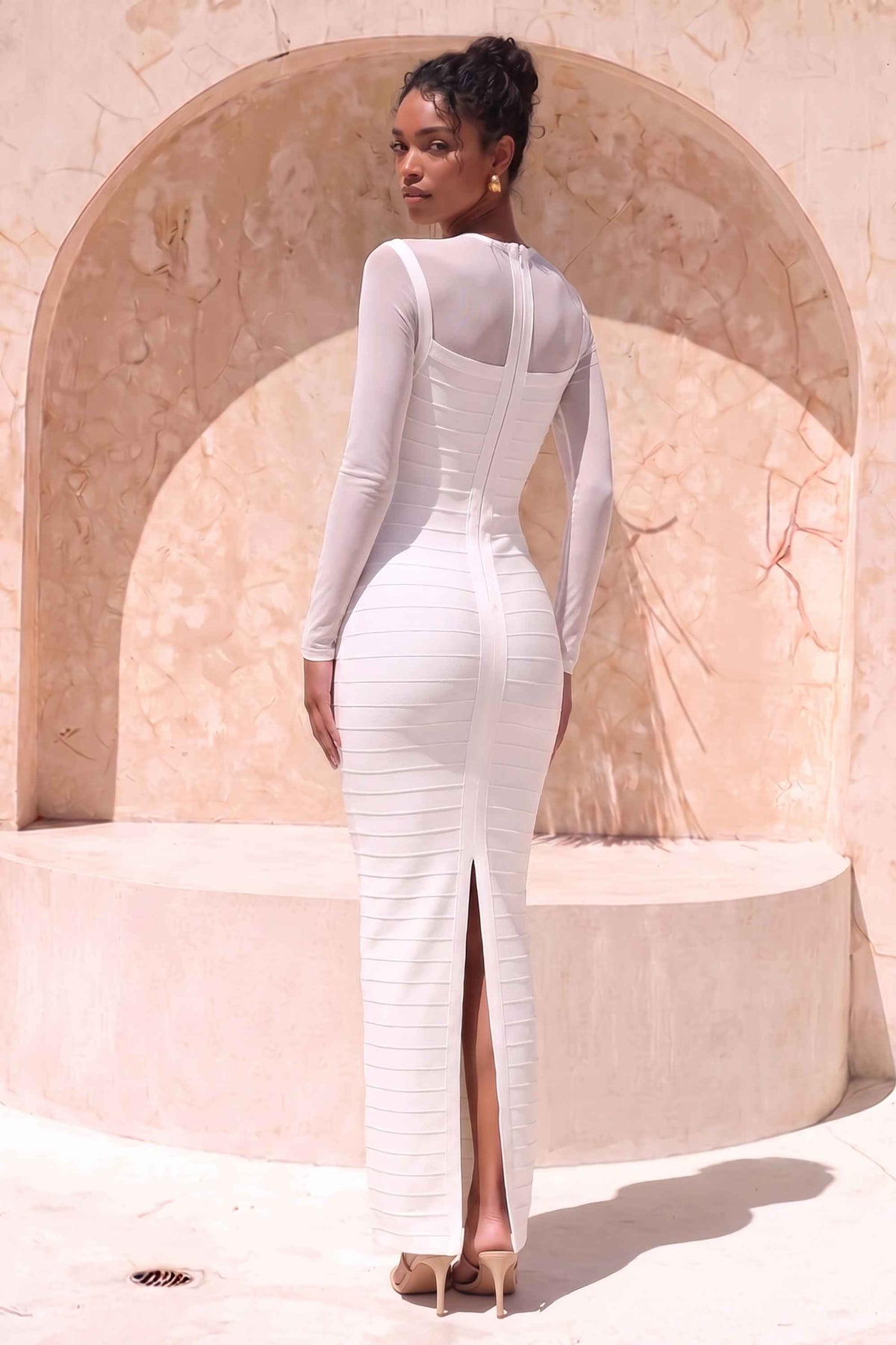 Woman wearing a figure flattering Robin Long Sleeve Bandage Maxi Dress - White Pearl BODYCON COLLECTION Pty Ltd