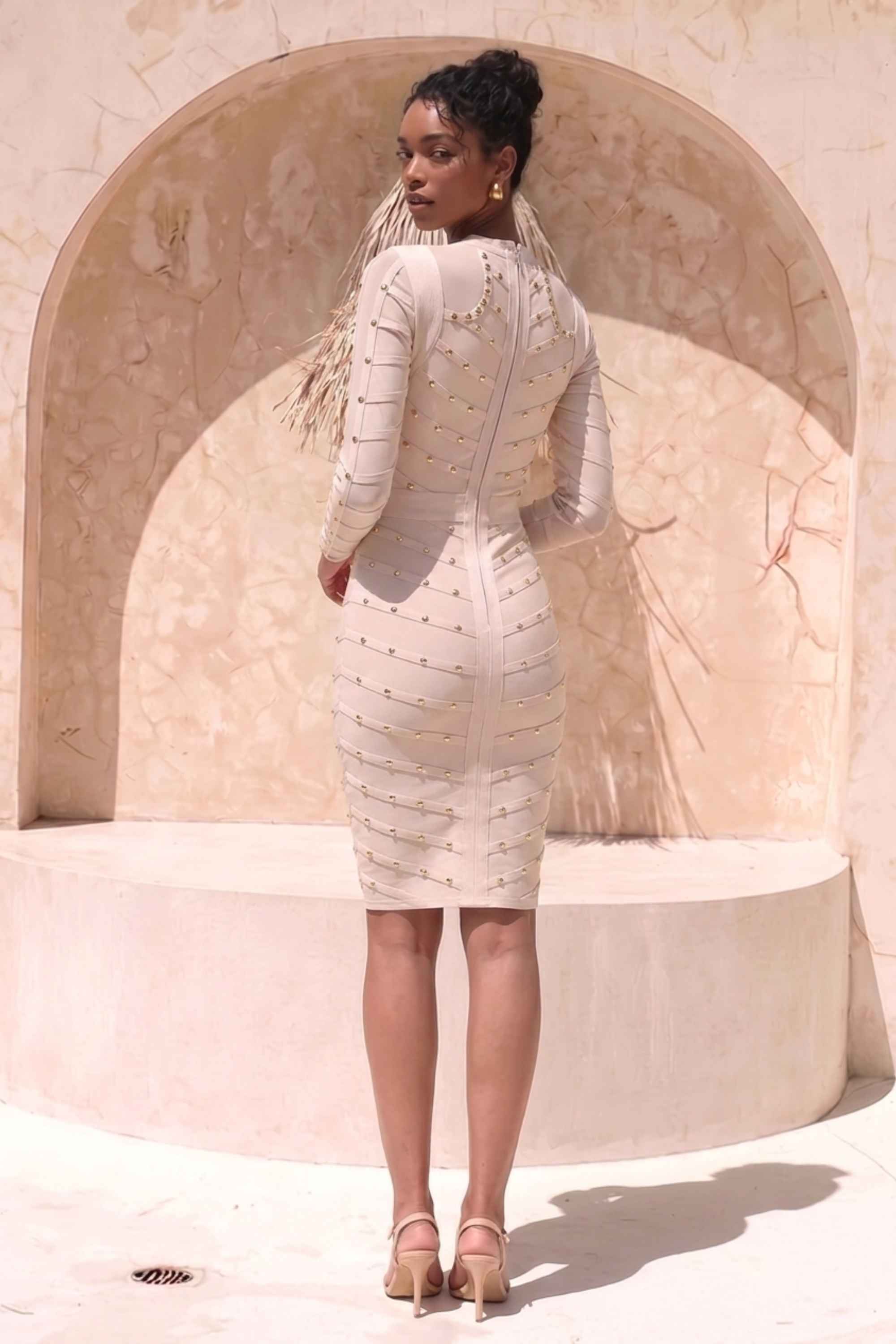 Woman wearing a figure flattering Rosa Long Sleeve Bodycon Dress - Cream BODYCON COLLECTION
