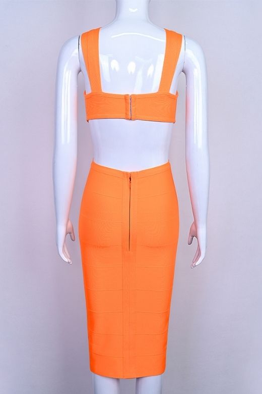 Woman wearing a figure flattering Sasha Bandage Midi Dress - Apricot Orange BODYCON COLLECTION