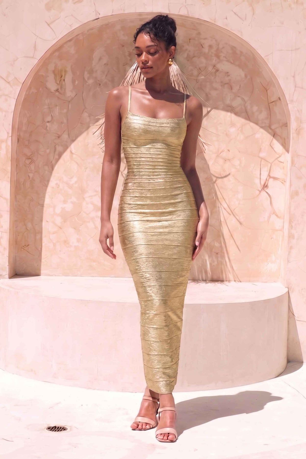 Woman wearing a figure flattering Scarlett Bandage Maxi Dress - Gold BODYCON COLLECTION Pty Ltd