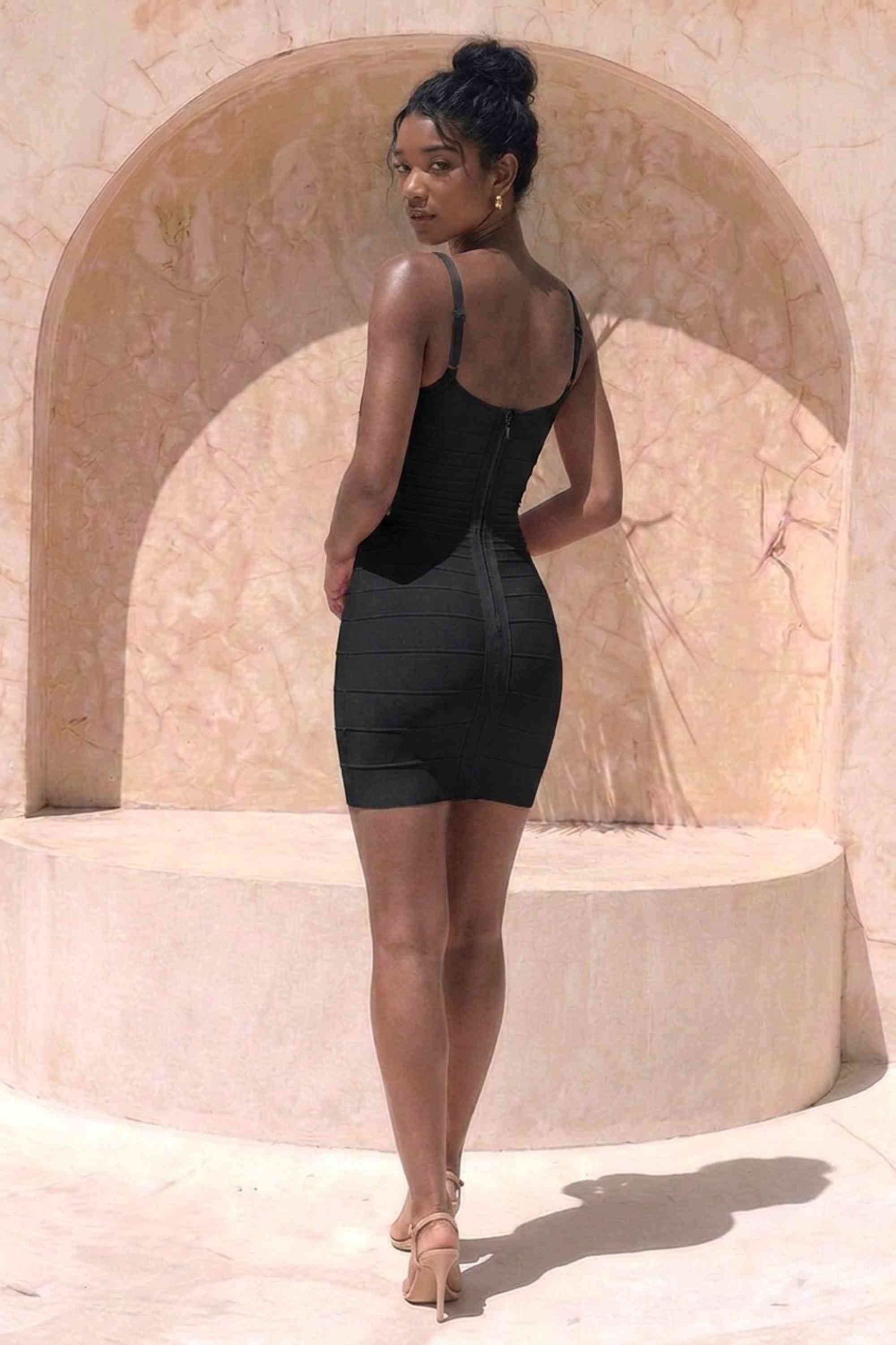 Woman wearing a figure flattering Scarlett Bandage Mini Dress - Classic Black BODYCON COLLECTION Pty Ltd