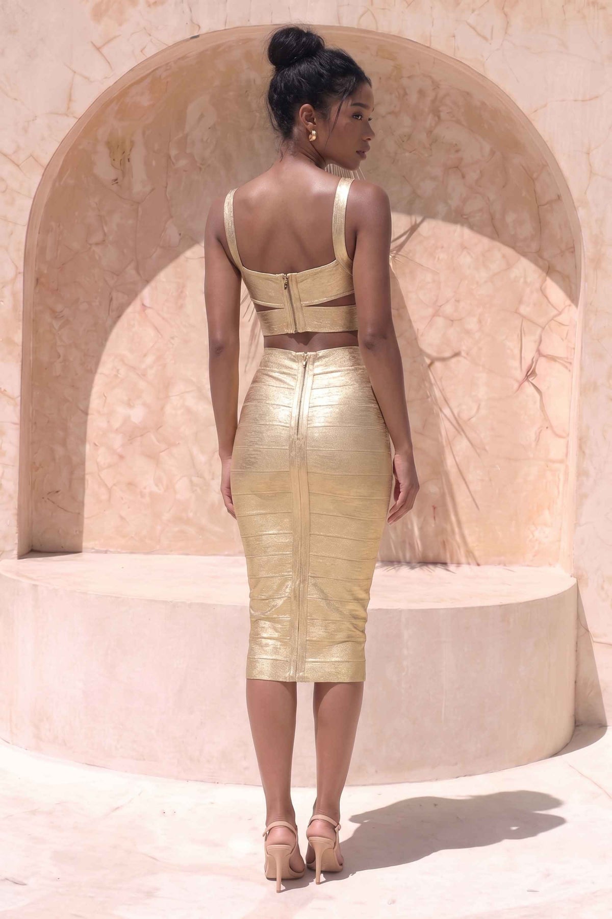 Woman wearing a figure flattering Selene Bandage Crop Top and Midi Skirt Set - Gold BODYCON COLLECTION Pty Ltd