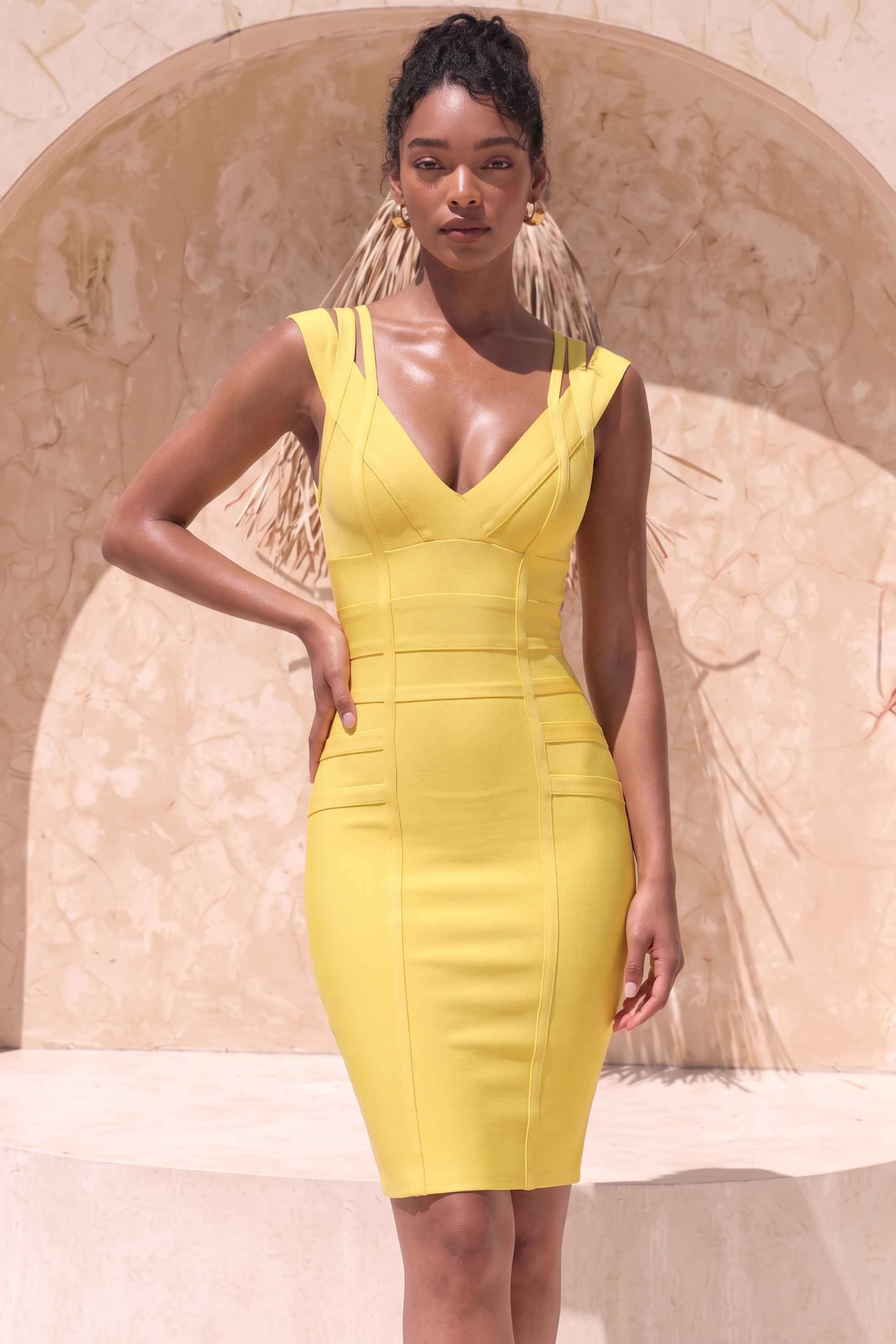 Woman wearing a figure flattering Sia Bandage Dress - Sun Yellow Bodycon Collection