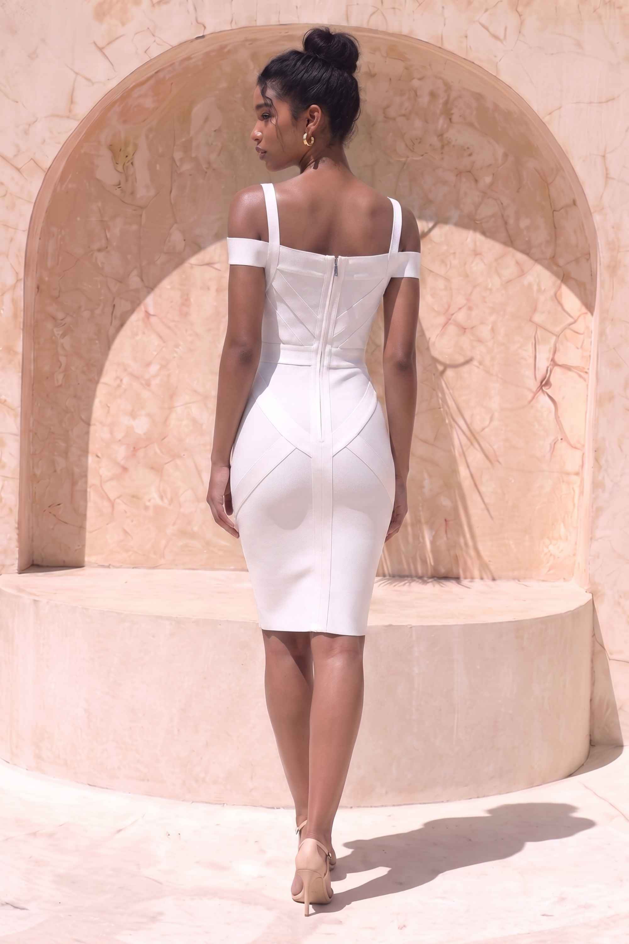 Woman wearing a figure flattering Sophia Bandage Dress - White Pearl Bodycon Collection
