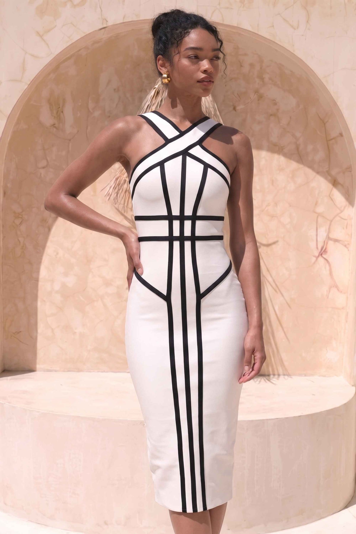 Woman wearing a figure flattering Suki Bandage Midi Dress - White Pearl BODYCON COLLECTION