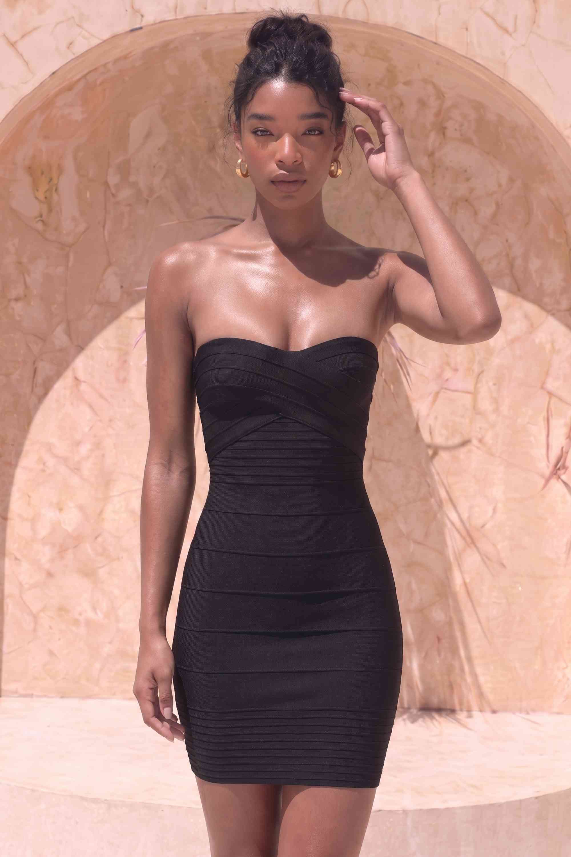Woman wearing a figure flattering  Aaliyah Bandage Mini Dress - Classic Black BODYCON COLLECTION