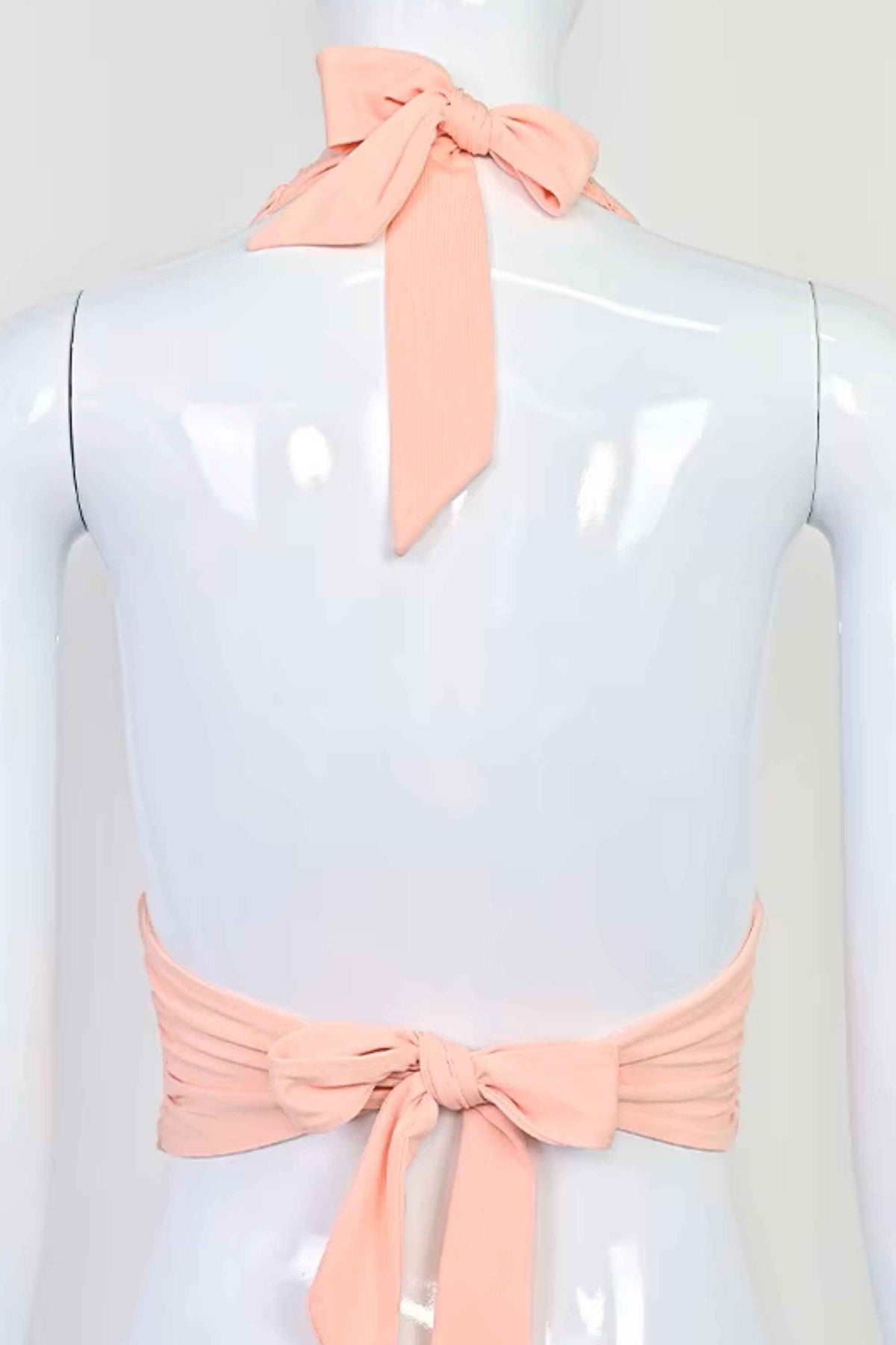 Woman wearing a figure flattering  Aby Halter Top - Pink Peach Fuzz BODYCON COLLECTION Pty Ltd