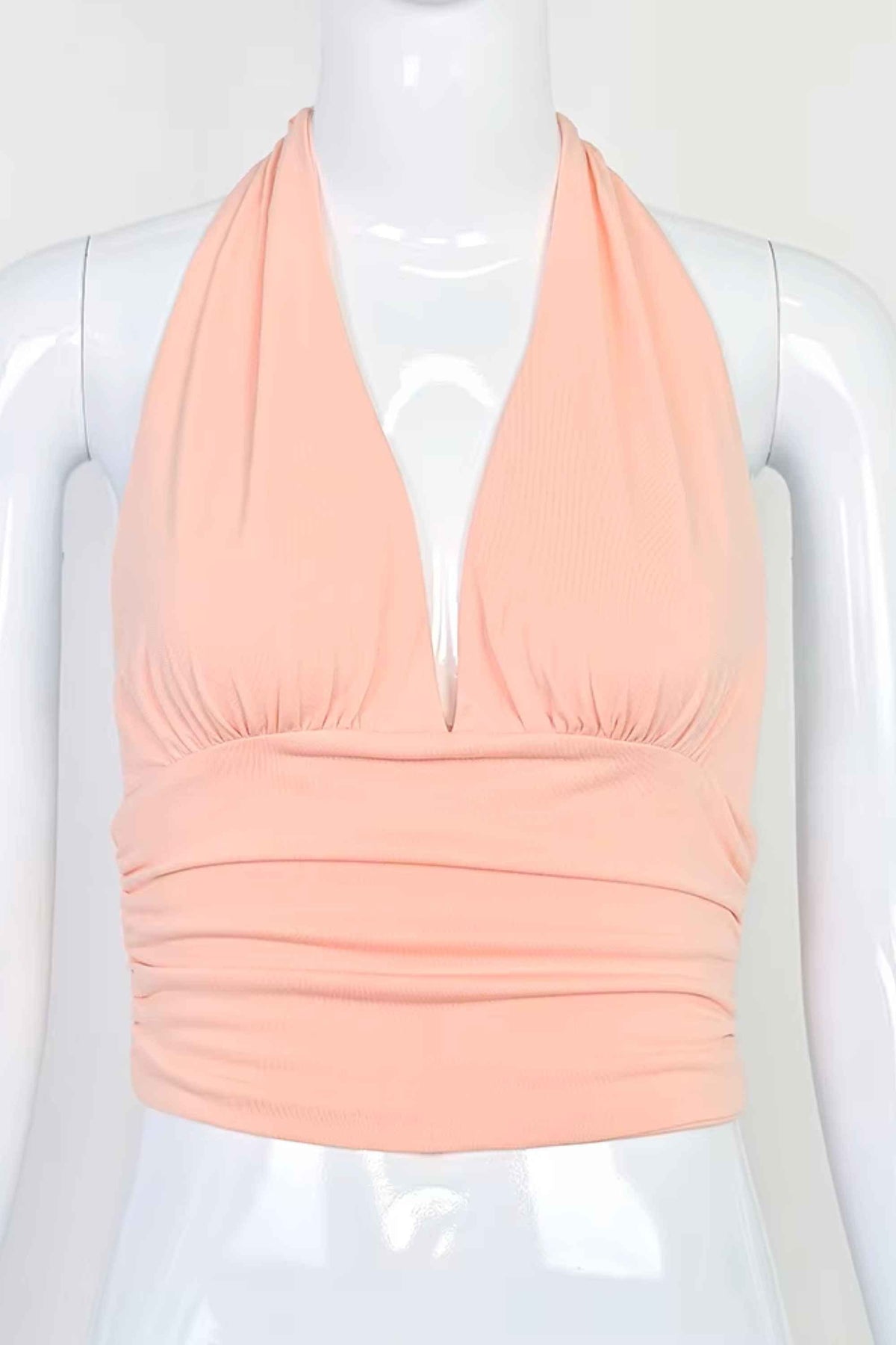 Woman wearing a figure flattering  Aby Halter Top - Pink Peach Fuzz BODYCON COLLECTION Pty Ltd