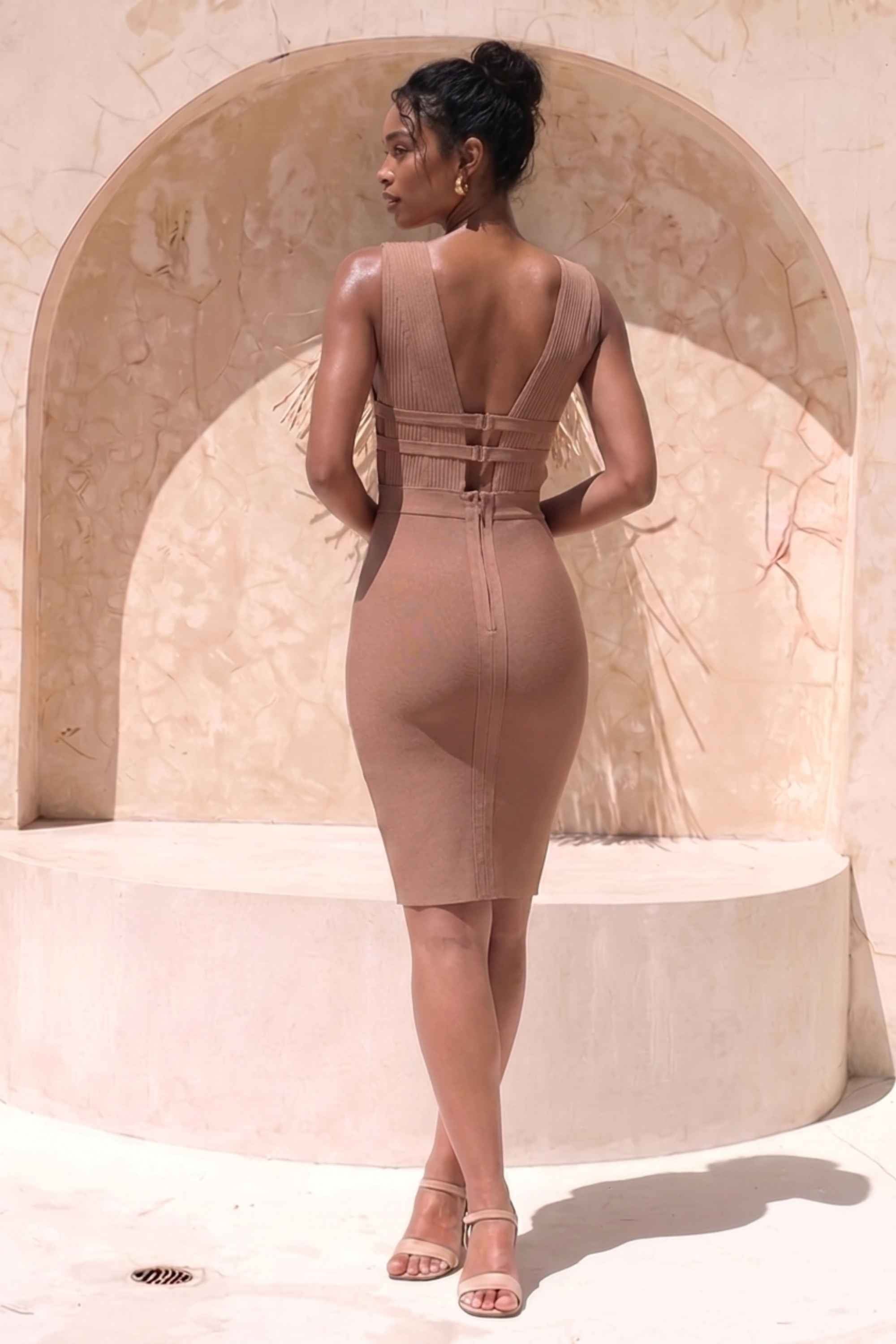 Woman wearing a figure flattering  Bay Bandage Dress - Nude Bodycon Collection