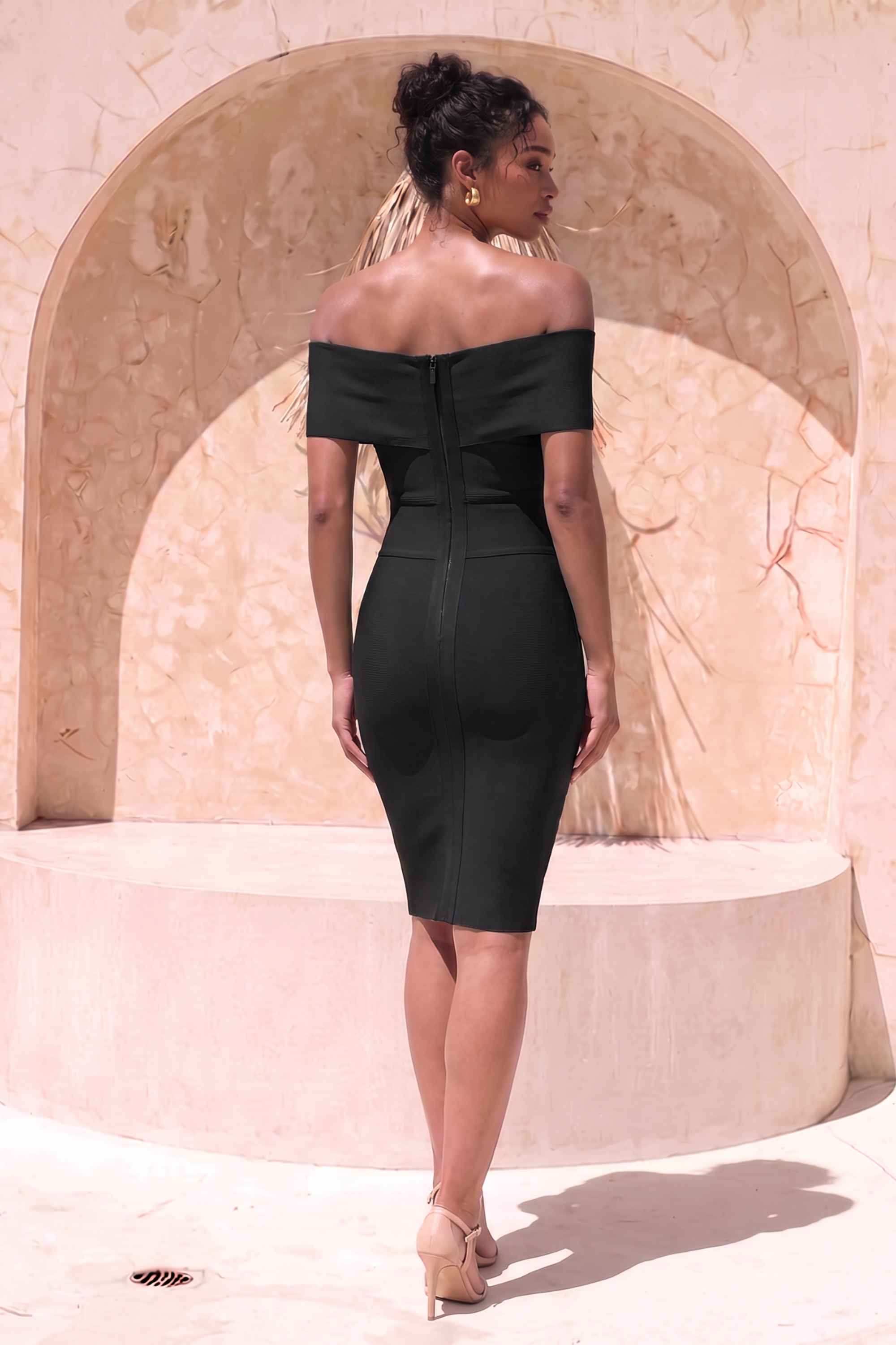 Woman wearing a figure flattering  Bea Bandage Dress - Classic Black Bodycon Collection