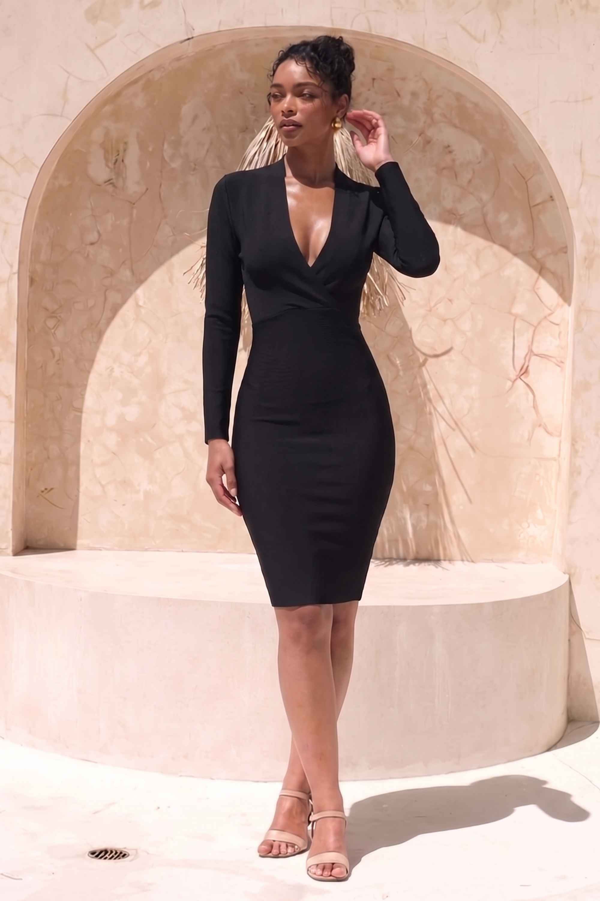 Woman wearing a figure flattering  Blaire Long Sleeve Bandage Dress - Classic Black BODYCON COLLECTION