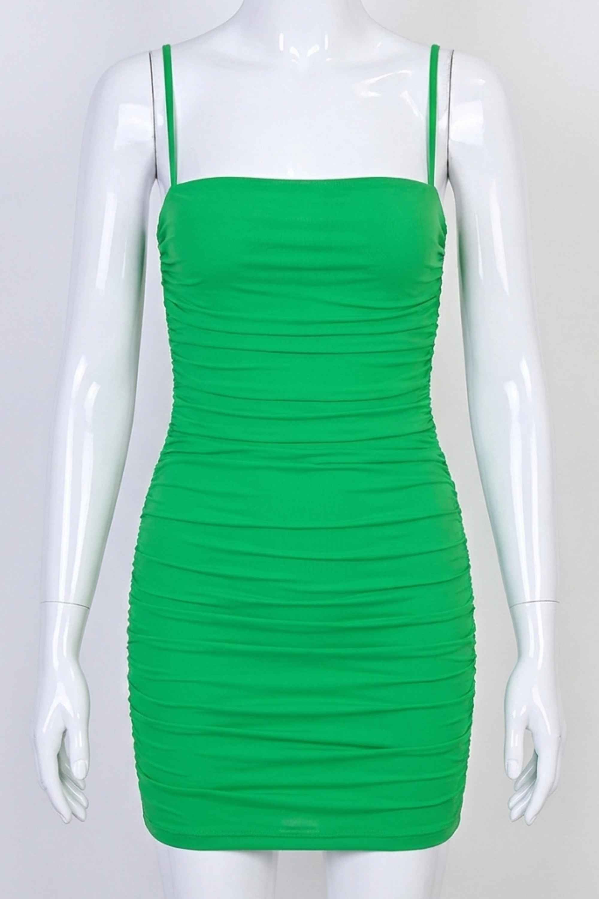 Woman wearing a figure flattering  Cassie Bodycon Wrap Mini Dress - Emerald Green BODYCON COLLECTION