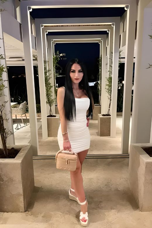 Woman wearing a figure flattering  Cassie Bodycon Wrap Mini Dress - Pearl White BODYCON COLLECTION