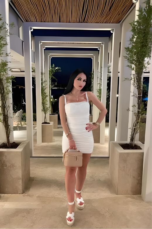 Woman wearing a figure flattering  Cassie Bodycon Wrap Mini Dress - Pearl White BODYCON COLLECTION