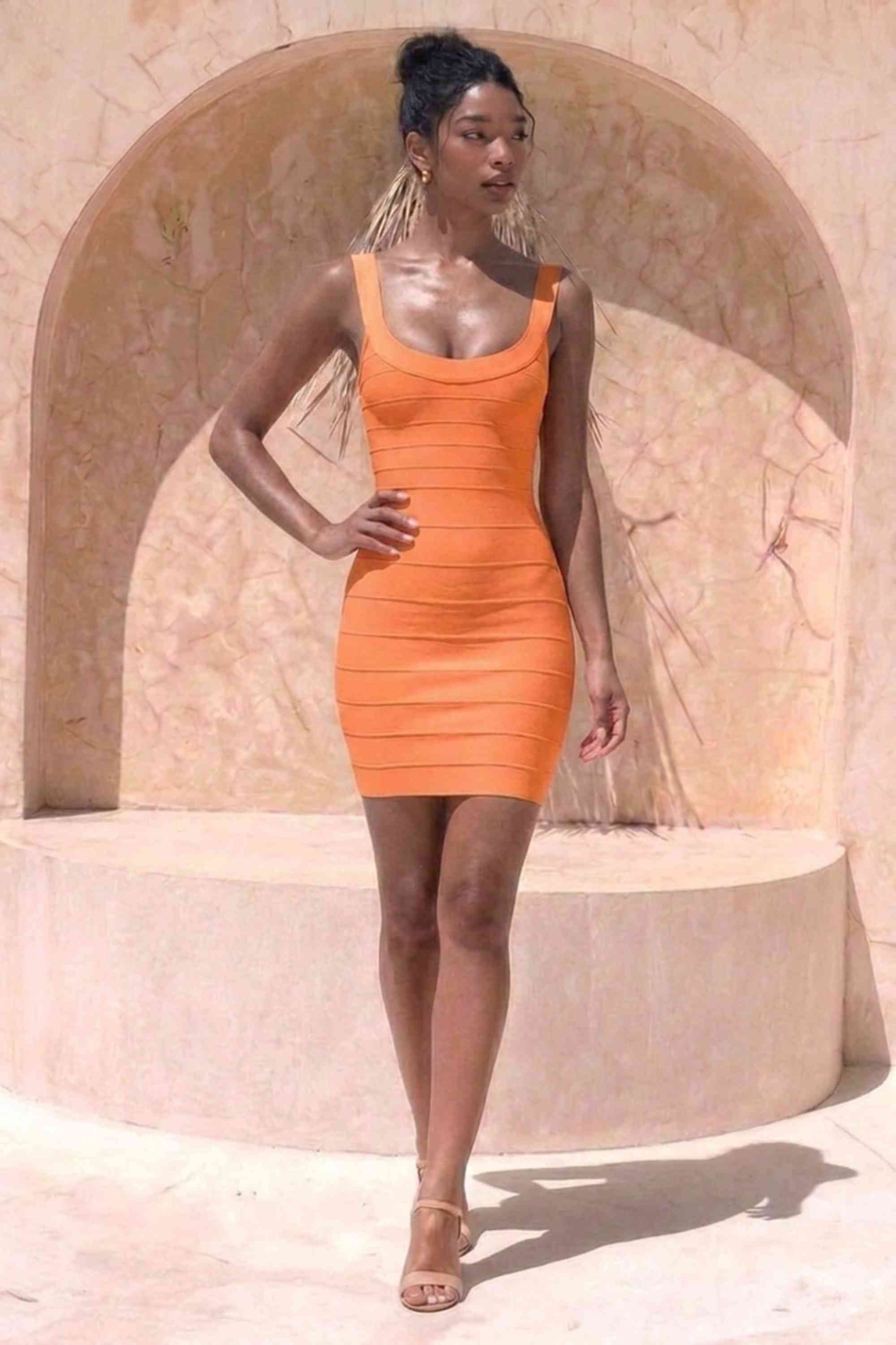 Woman wearing a figure flattering  Cindy Bandage Mini Dress - Apricot Orange BODYCON COLLECTION Pty Ltd