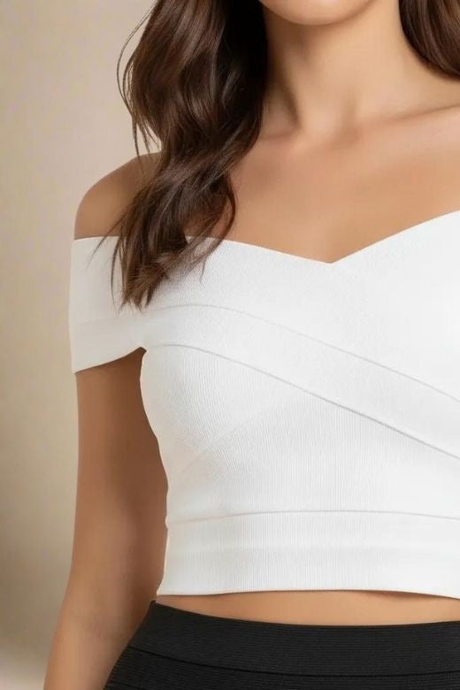 Woman wearing a figure flattering  Cindy Bandage Off Shoulder Crop Top - White Pearl BODYCON COLLECTION