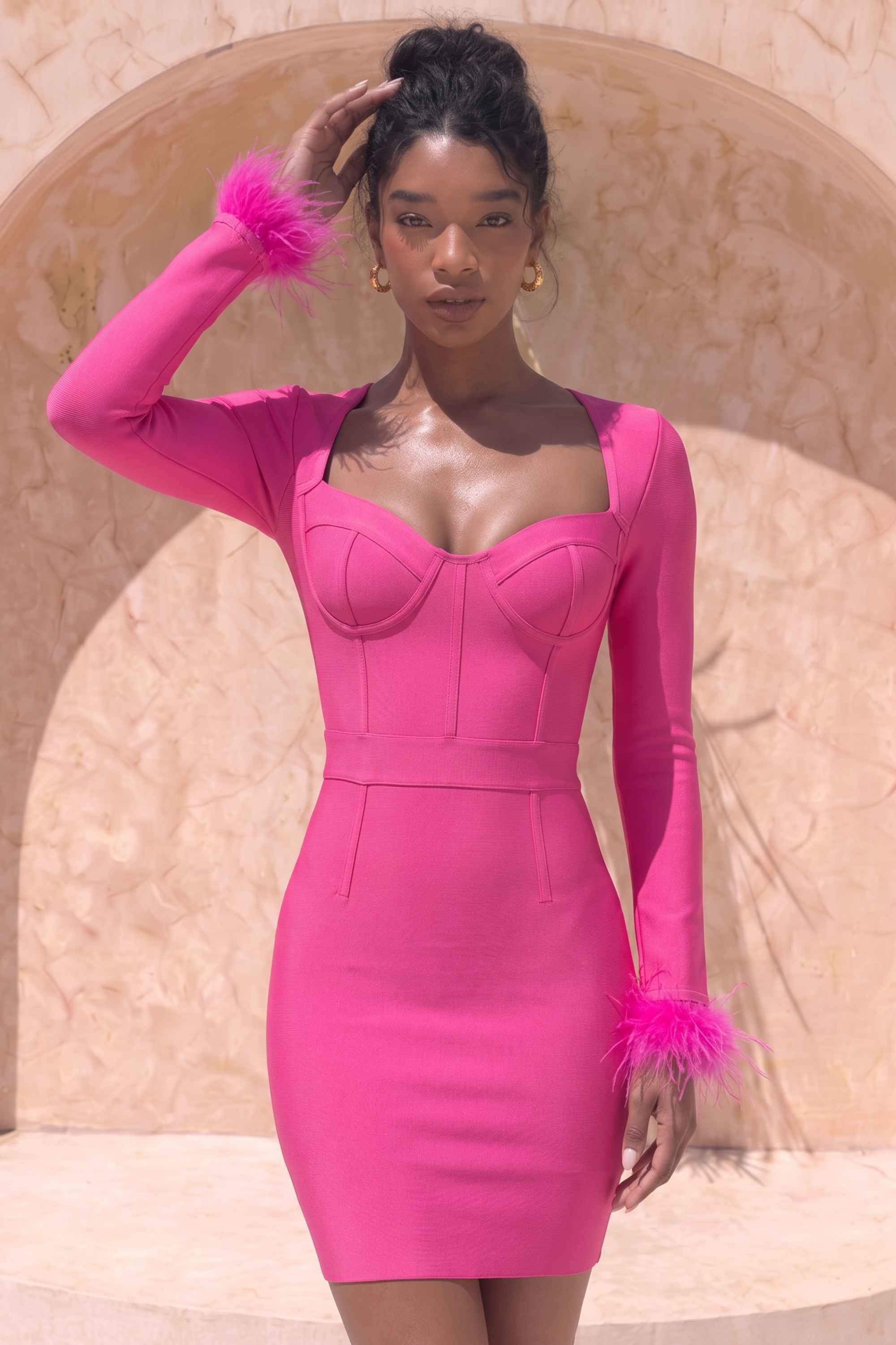 Woman wearing a figure flattering  Erin Long Sleeve Mini Dress - Hot Pink BODYCON COLLECTION