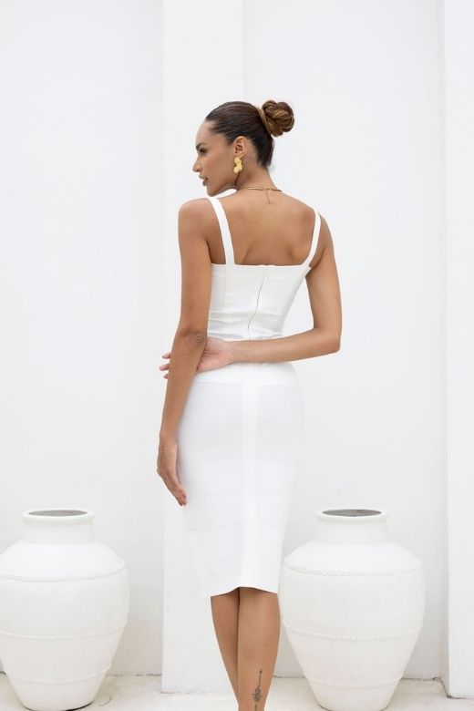 Woman wearing a figure flattering  Heidi Bandage Midi Dress - White Pearl Bodycon Collection