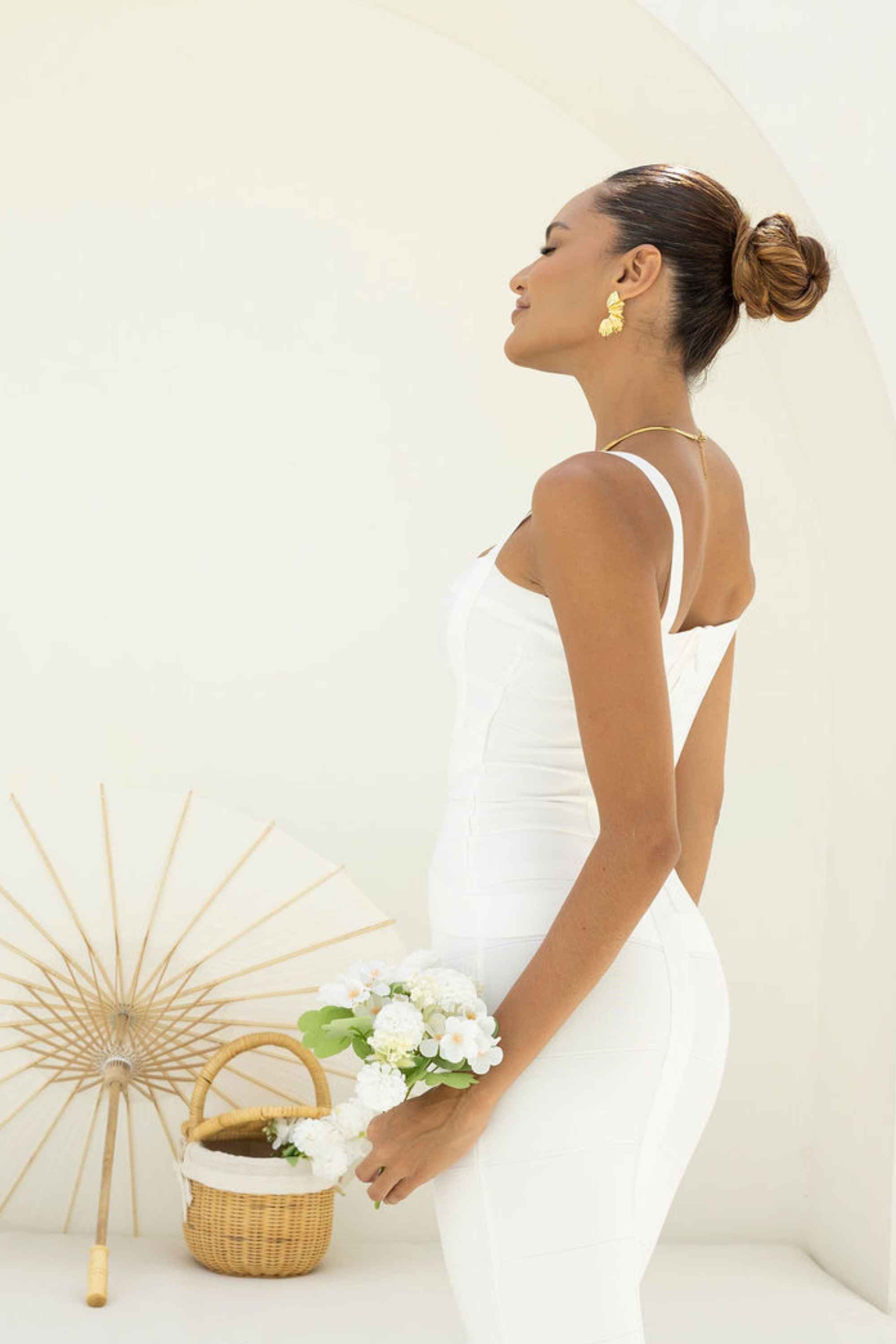 Woman wearing a figure flattering  Heidi Bandage Mini Dress - Classic Black Bodycon Collection