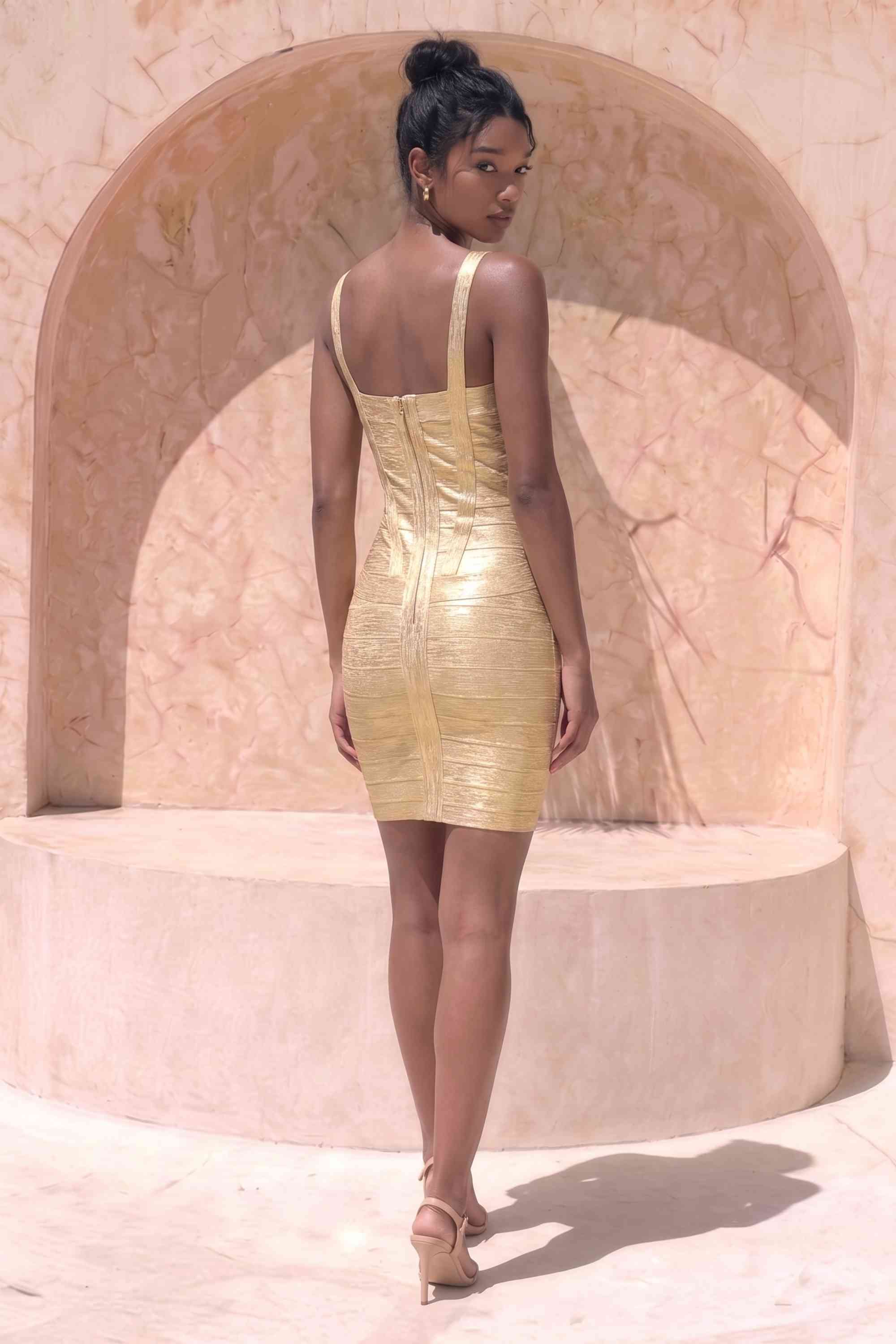 Woman wearing a figure flattering  Heidi Bandage Mini Dress - Gold Bodycon Collection